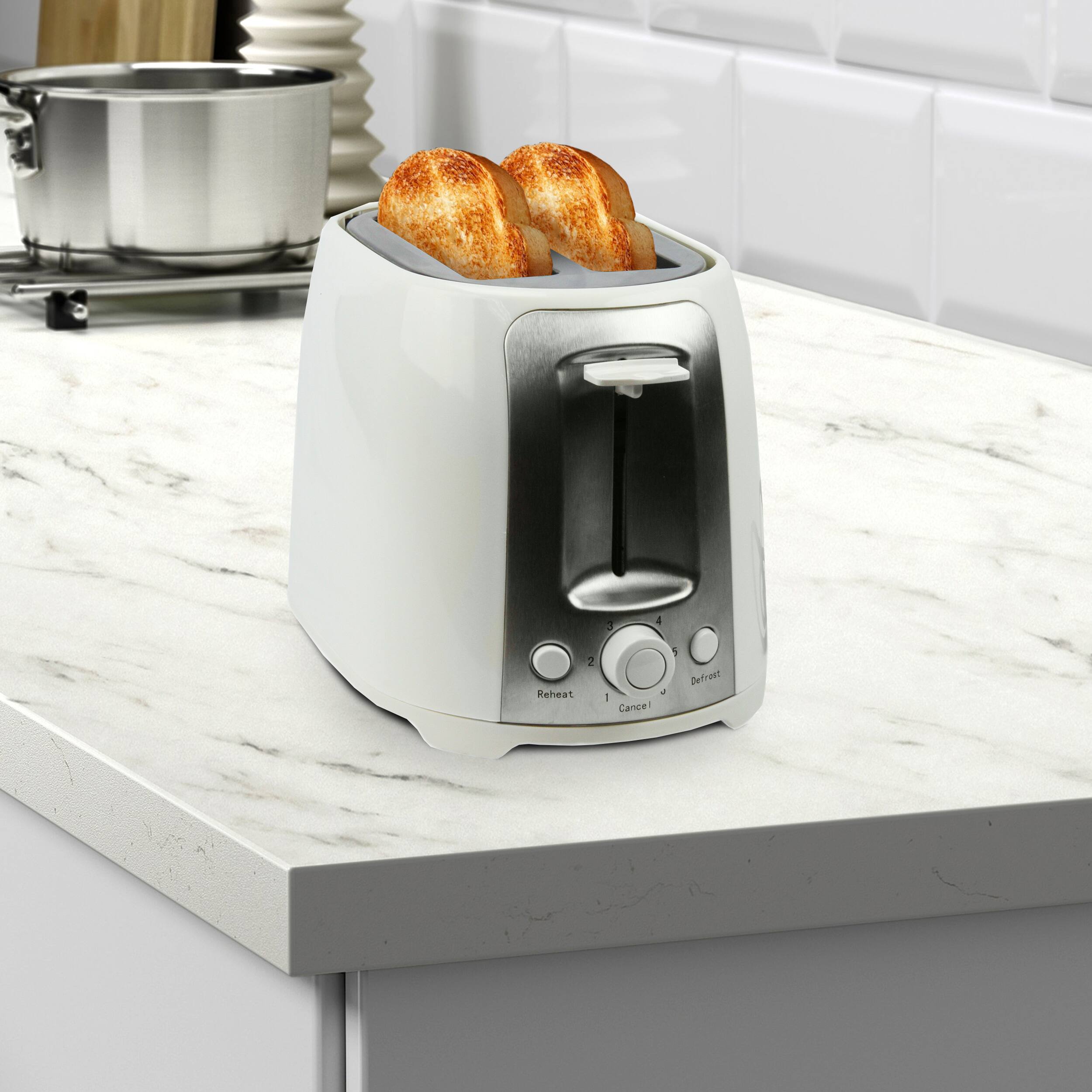 The text on the image reads "4 Reheat 2 + - Cancel 1 Defrest." However, this text is not related to the image of the toaster oven with toast inside. The image shows a white toaster oven with toast inside, placed on a countertop.