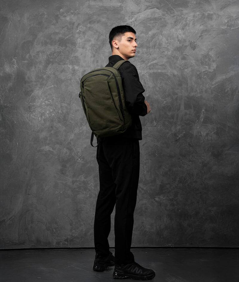 Angle. ALPAKA - Traverse Backpack Laptop Backpack for Men, Backpack with Laptop Compartment (16"), Clamshell Travel Pack, Bottle Sleeve - Green Axoflux 400D Ripstop Nylon.