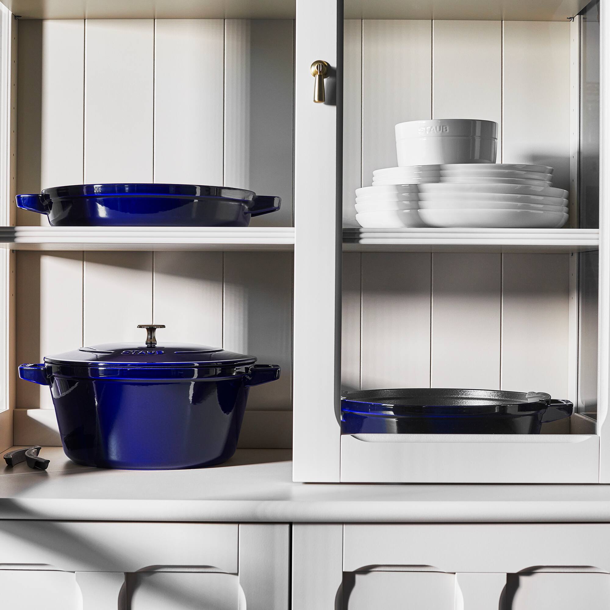 The text on the image reads:

- "STAUB" (on the pot and lid)
- "STAUB" (on the container)