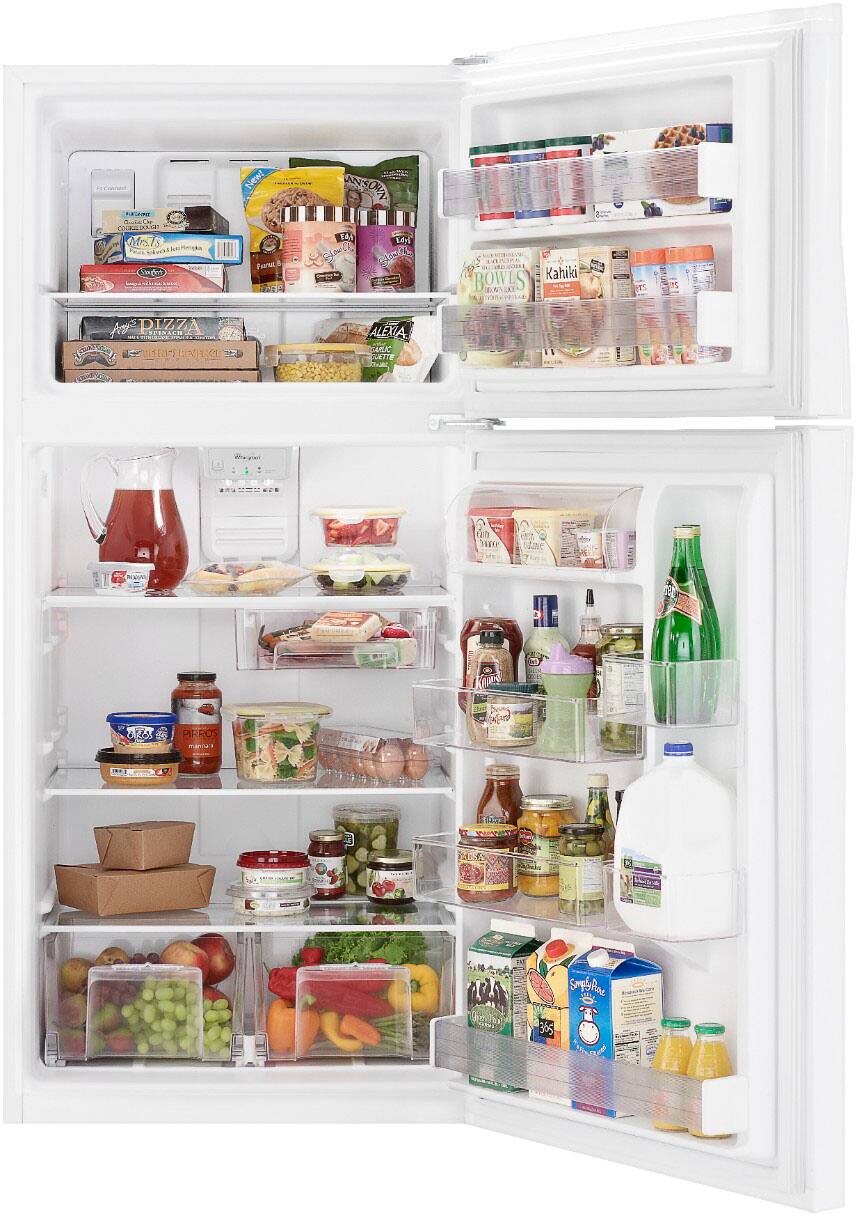 The image shows a well-stocked refrigerator with various food items and drinks. There are multiple bottles, including a bottle of milk, and a variety of fruits and vegetables, such as apples and oranges. The refrigerator also contains a few bowls and a cup. The refrigerator is filled with a diverse assortment of food items, making it a convenient and accessible source of nourishment for the household.
