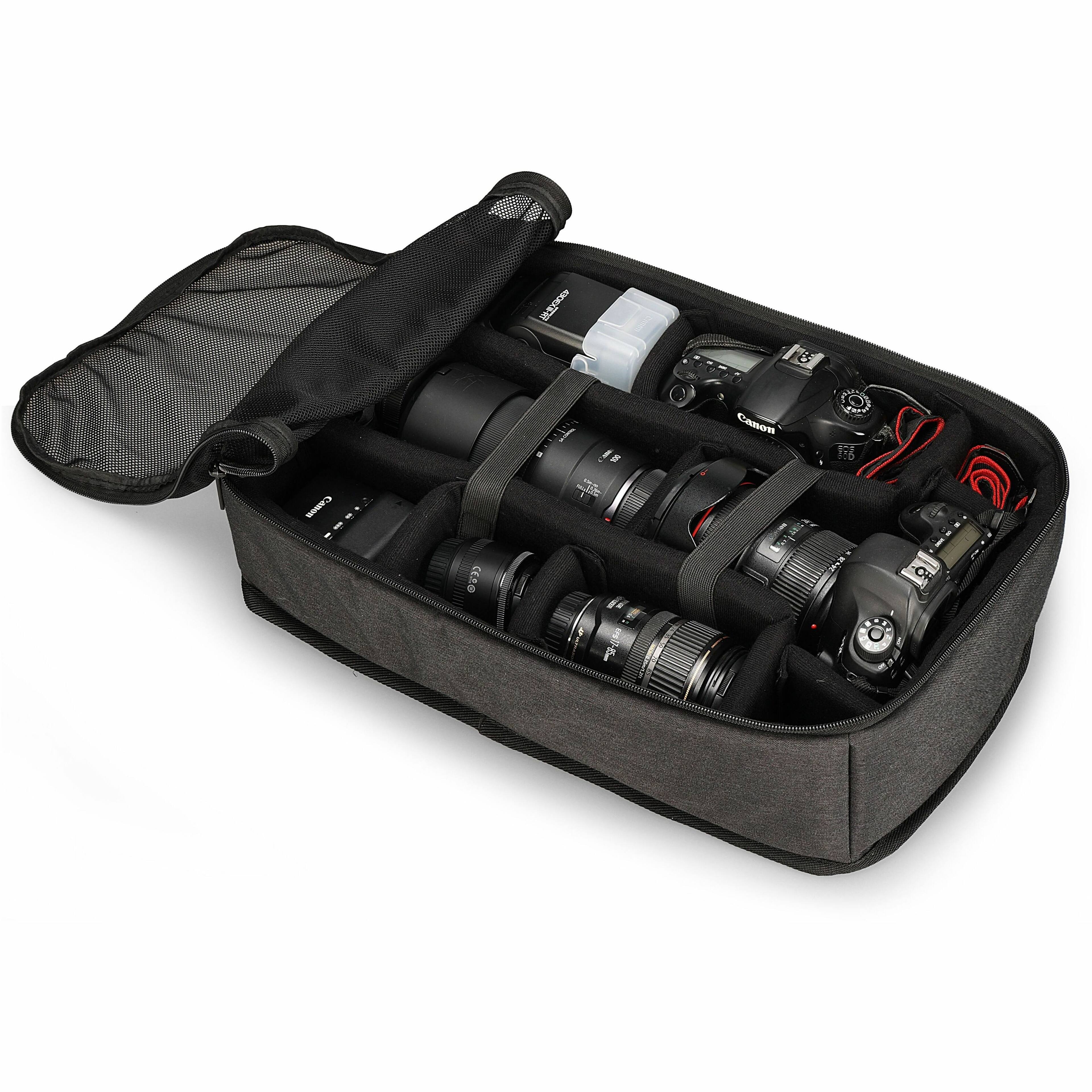 The image shows a black case with a variety of camera equipment inside. The case contains a Canon camera, a lens, and a flash. The camera equipment is organized in the case, making it easy to access and transport.