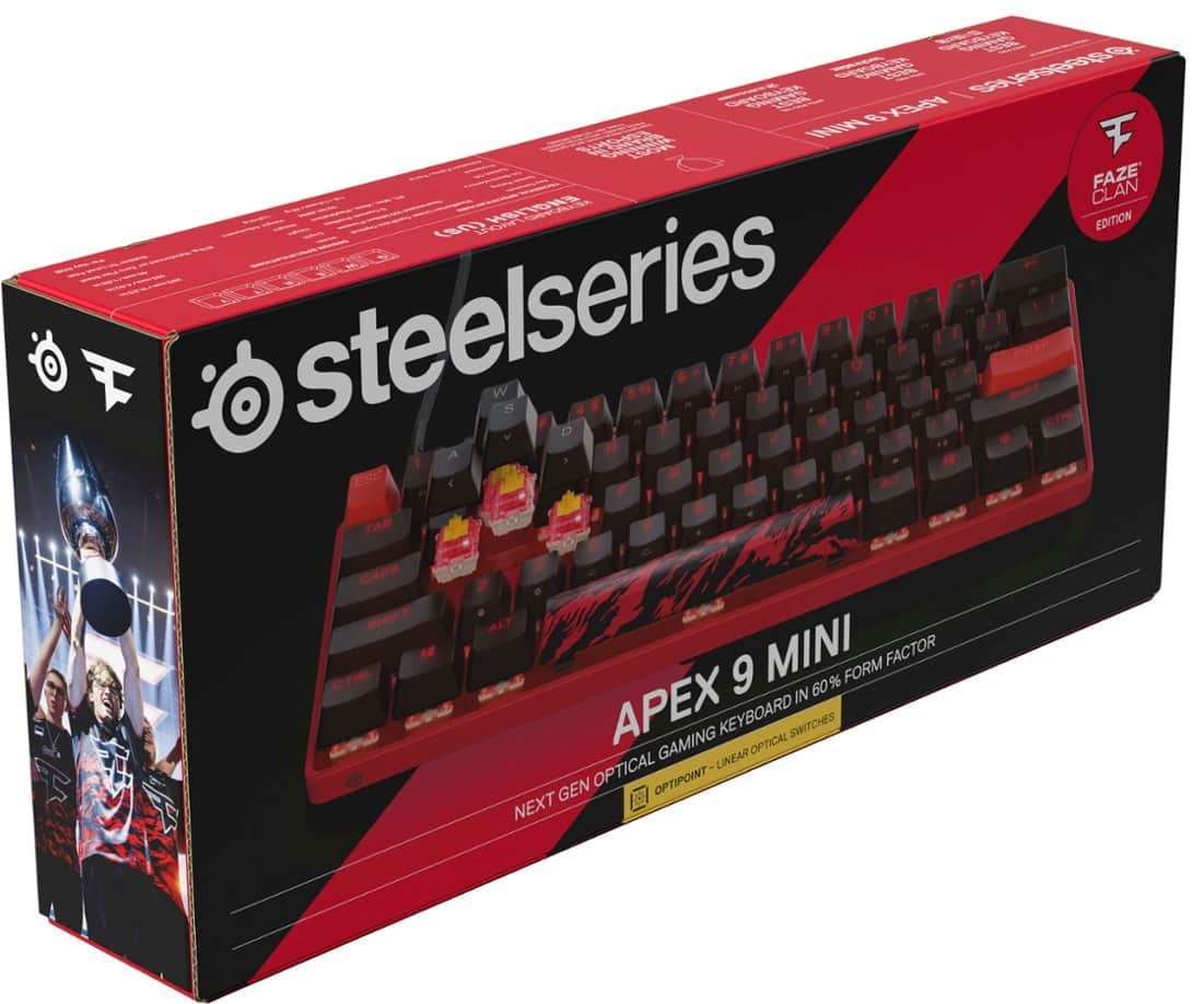 The image features a red and black box containing a gaming keyboard from the Steelseries brand. The keyboard is designed in collaboration with the Faze Clan and has a unique design. The box is labeled with the name "Steelseries" and the keyboard is advertised as having optical switches and a 60% form factor. The box also includes a mini keyboard and a set of keycaps.