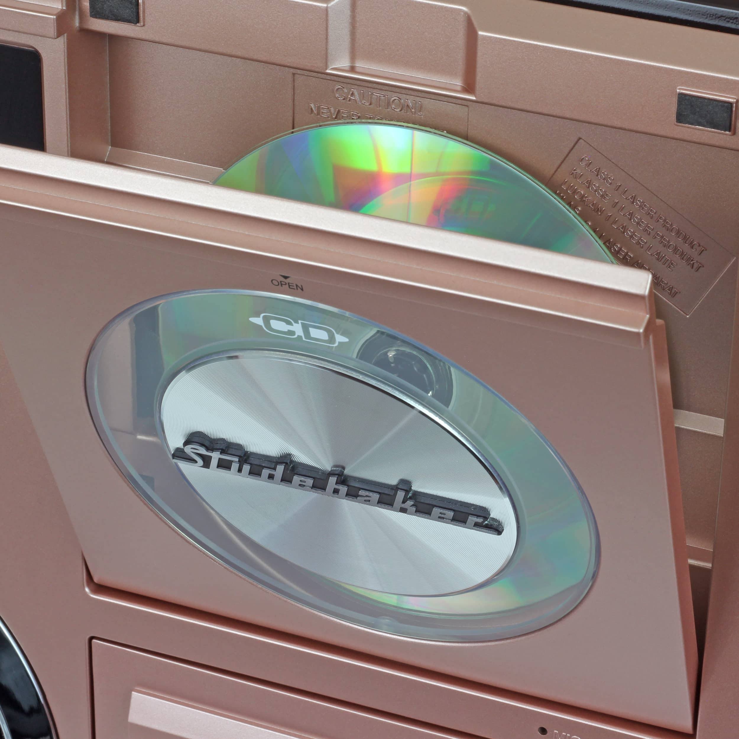 The text on the image reads: "NEVAS CAUTION OPEN CD KASEE K 2LASER d OTNE d LASER d 114533 LASERPRODUCT EAEEBLANE KO3ES FEBA LANE FRODRKT HAT Studohakerm R."