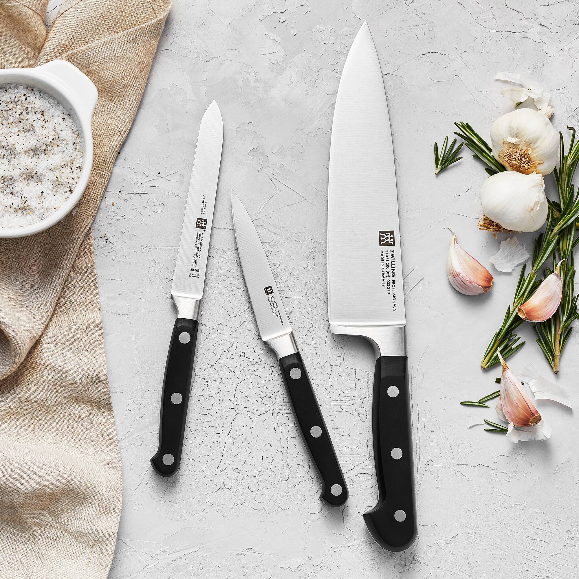 The text on the knives reads:

"ZWILLING
J.A. HENCKELS
GERMANY
STAINLESS
HIGH CARBON
STEEL
MADE IN GERMANY"