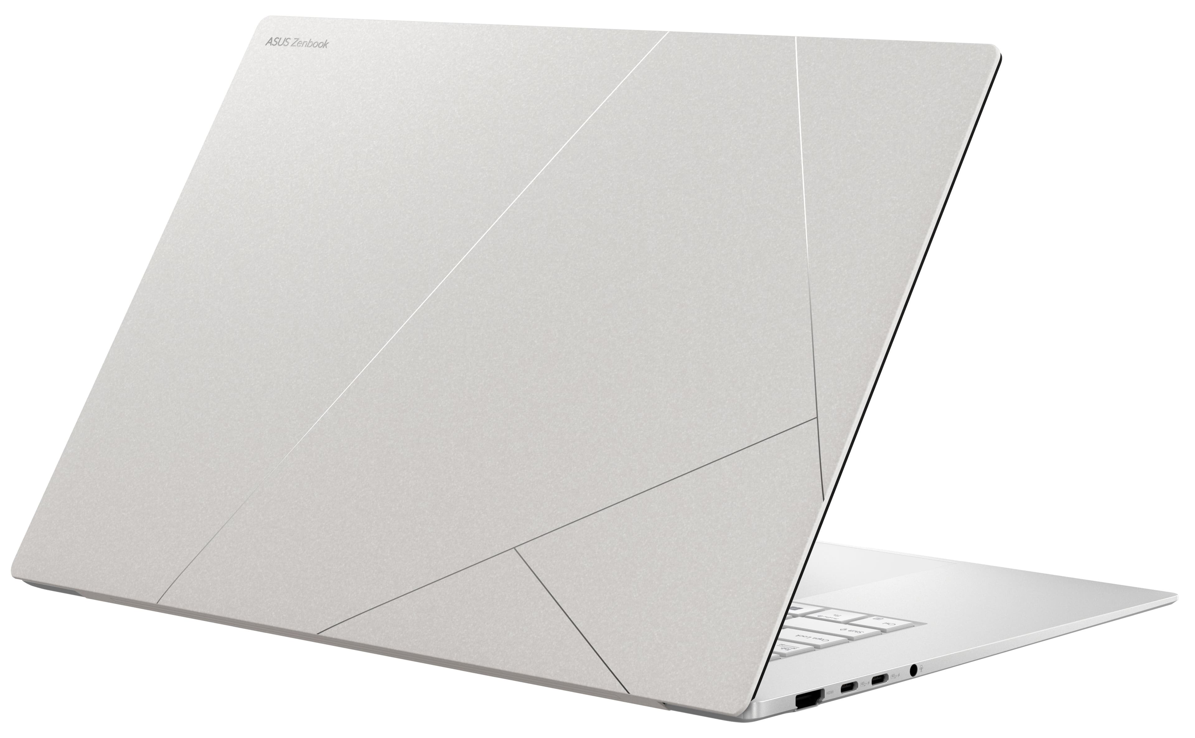 The image features a white laptop computer, which is an ASUS Zenbook. The laptop is open and ready for use, with its screen facing the viewer. The design of the laptop is sleek and modern, with a silver finish that gives it a professional appearance. The laptop is likely equipped with the latest technology and features, making it a reliable and efficient tool for work or personal use.
