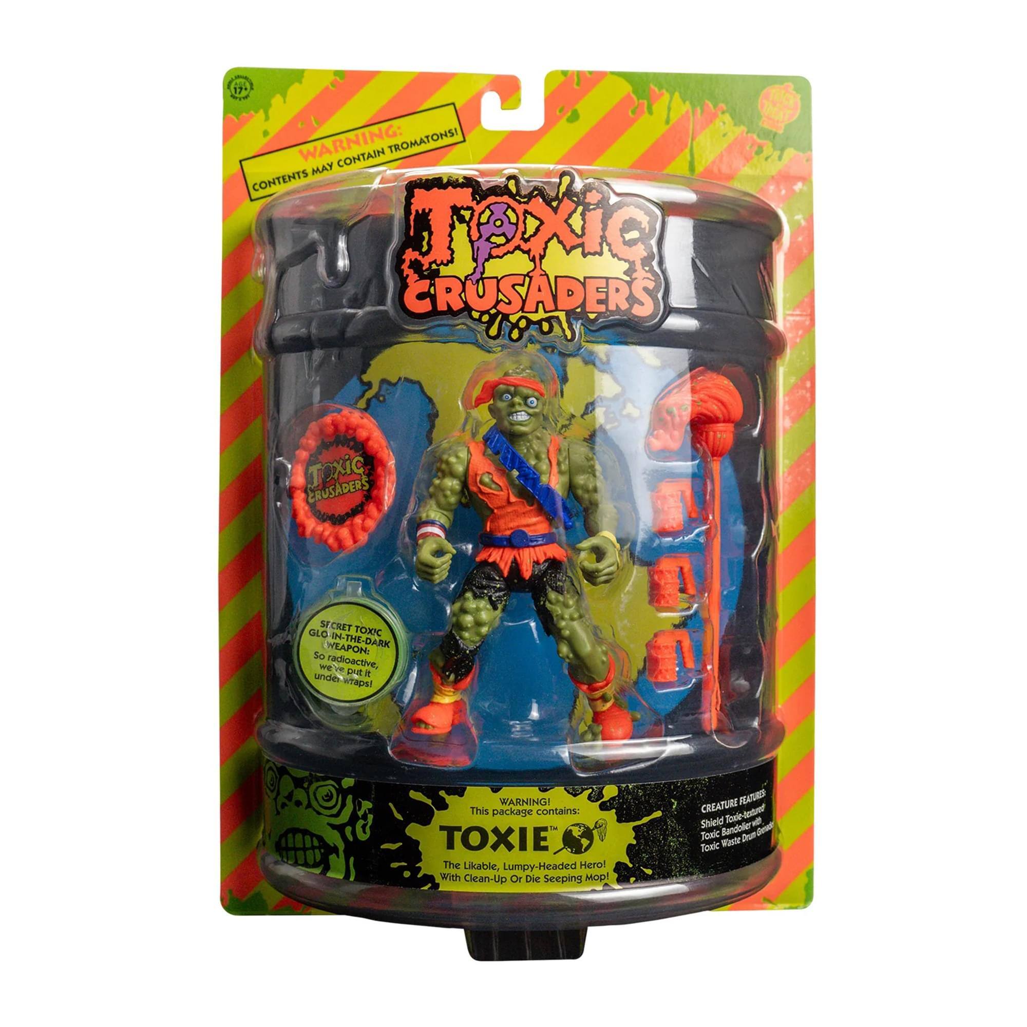**WARNING: CONTENTS MAY CONTAIN TROMATONS!**

**TOXIC CRUSADERS**

**GLORIOUS TOXIC WEAPONRY! WEAPONIZED, WEIRD, AND WICKED!**

**WARNING! This package contains:**

- **TOXIE** The Likable, Lumpy-Headed Hero! With Clean-Up Or Die Seeping Mop!

**CREATURE FEATURES:**
- Shield
- Toxic Bandole
- Toxic Waste Drum

**This package contains:**
- The Likable, Lumpy-Headed Hero!
- With Clean-Up Or Die Seeping Mop!