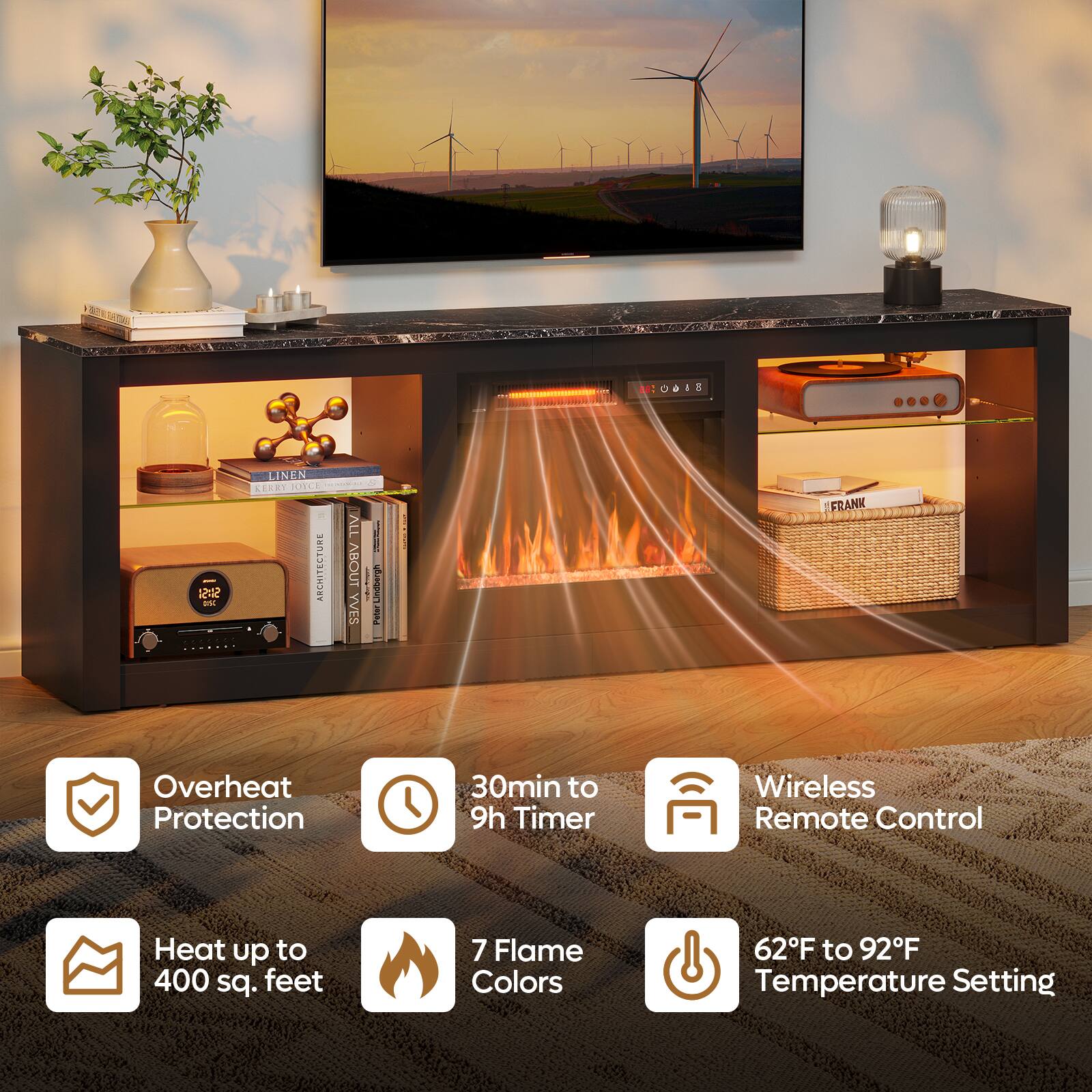 The image features a flat screen TV mounted on a wall, with a fireplace below it. The fireplace has a remote control and a timer, allowing for customizable temperature settings and flame colors. The TV is placed on a table, and there are several books nearby. The scene also includes a potted plant, adding a touch of greenery to the room.