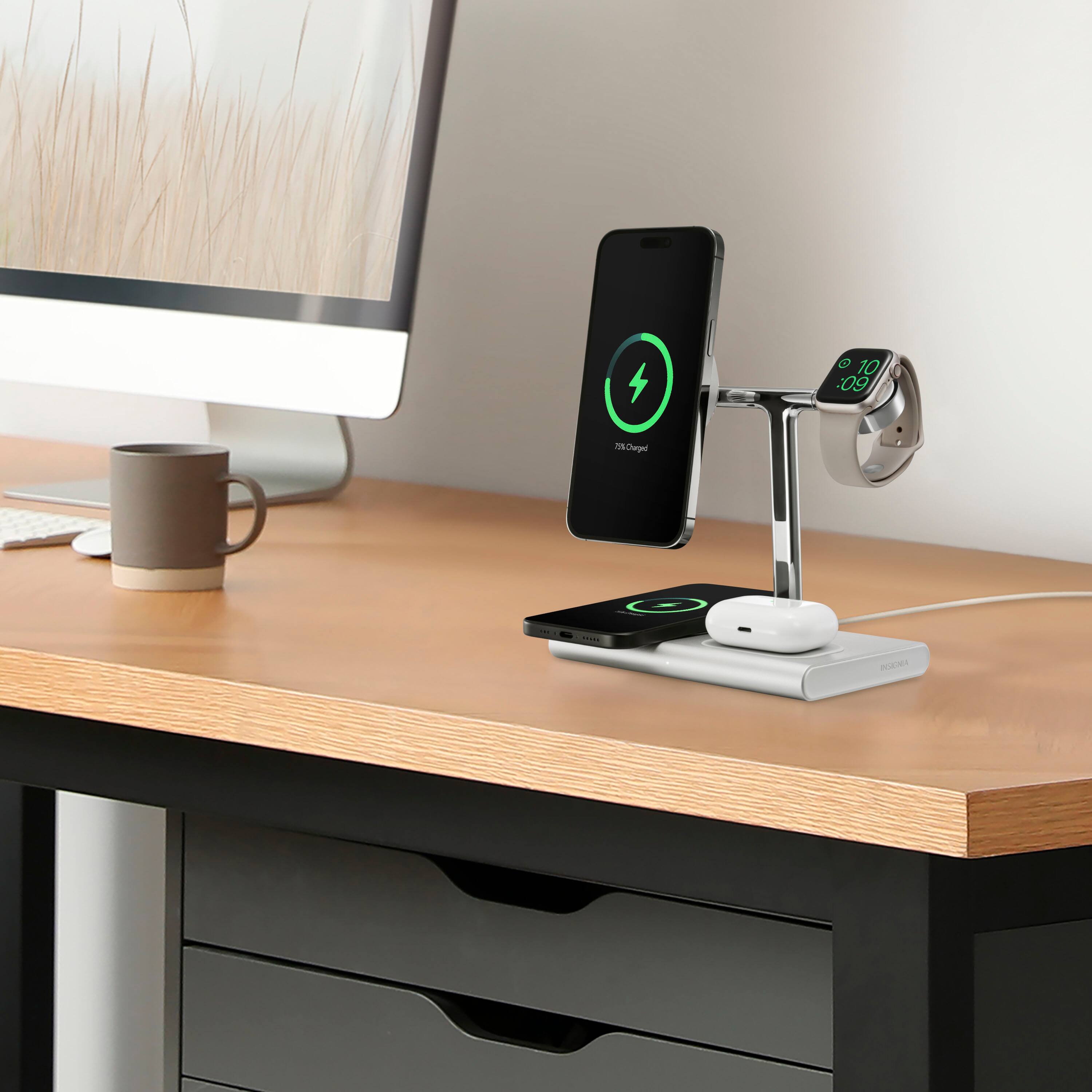 The image shows a desk with a cell phone, a computer monitor, and a coffee cup. The cell phone is placed on a stand, and there is a charging station nearby. The desk also has a keyboard and a mouse. The scene suggests that the person using this workspace is likely taking a break from work to enjoy a cup of coffee.