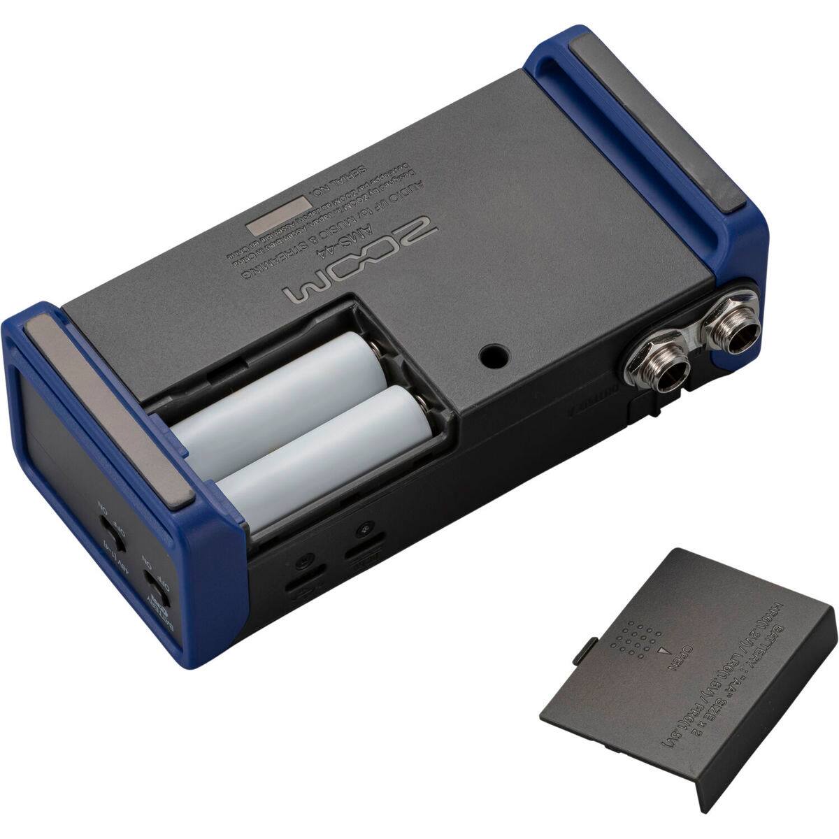 The text on the image can be grouped and corrected as follows:

- **Product Name:** ZOOM WOX2
- **Features:**
  - 1 ON/OFF SWITCH
  - 1 TRS INPUT
  - 1 TRS OUTPUT
  - 1 USB PORT
  - 1 DC IN PORT
  - 1 BATTERY COMPARTMENT
- **Battery Information:**
  - ZOOM
  - 1 x 2 AA BATTERIES
  - (Additional text on the battery is not fully legible, but it includes standard battery information and warnings.)

This text is likely found on the device and its battery, providing essential information about its features and usage.