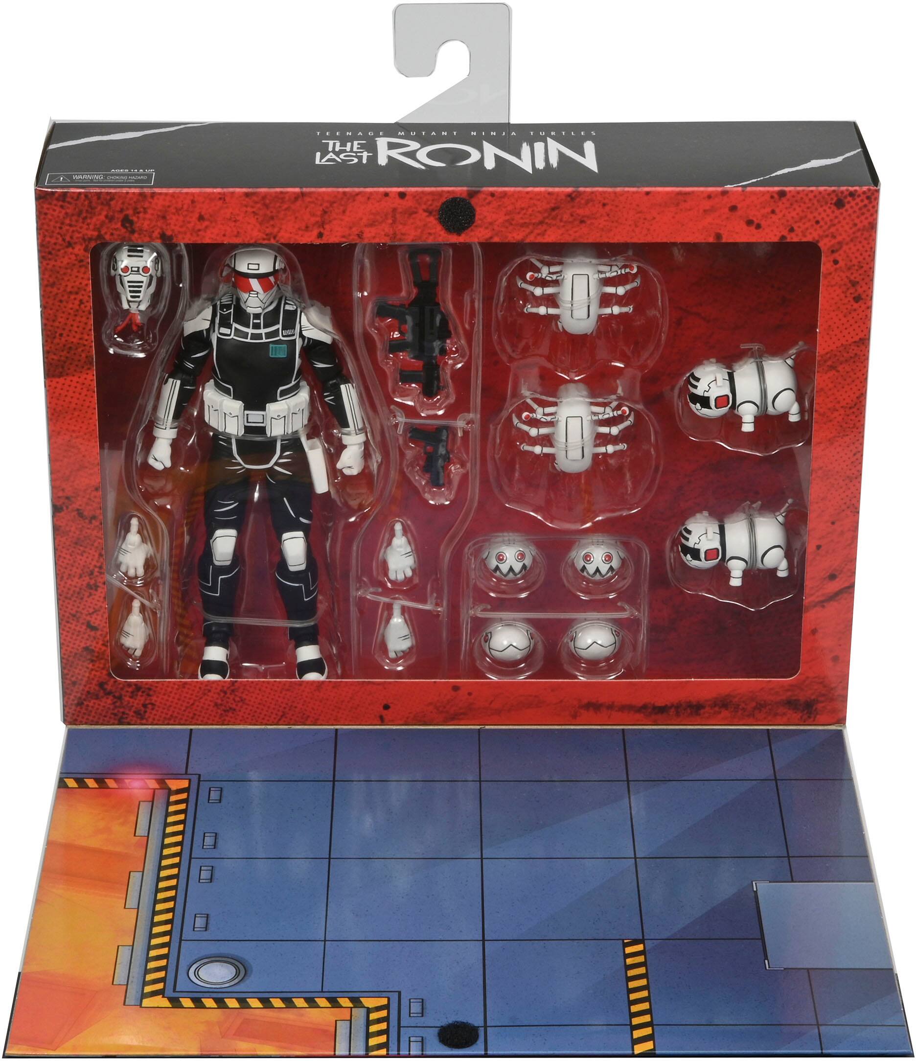 The Last Ronin II is a box set that includes a figure of a person and several other figures. The box is red and black, and the figures are displayed in a plastic case. The set also comes with a game board, adding to the overall gaming experience.