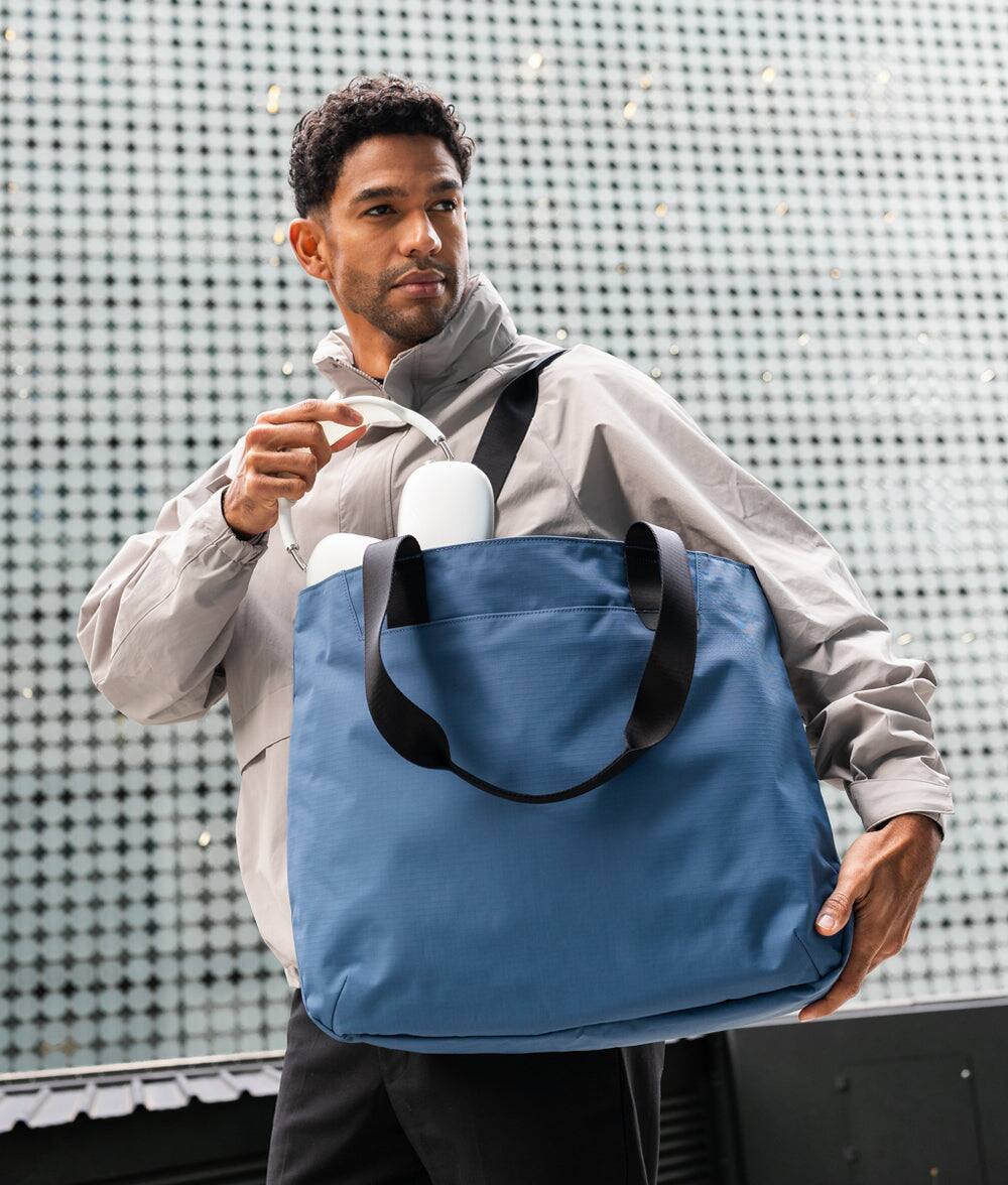 Angle. ALPAKA - Elements Tote 20L Laptop Tote Bag with Padded 16" Sleeve,Open Top with Magnetic Closure - Blue Axoflux 210D.