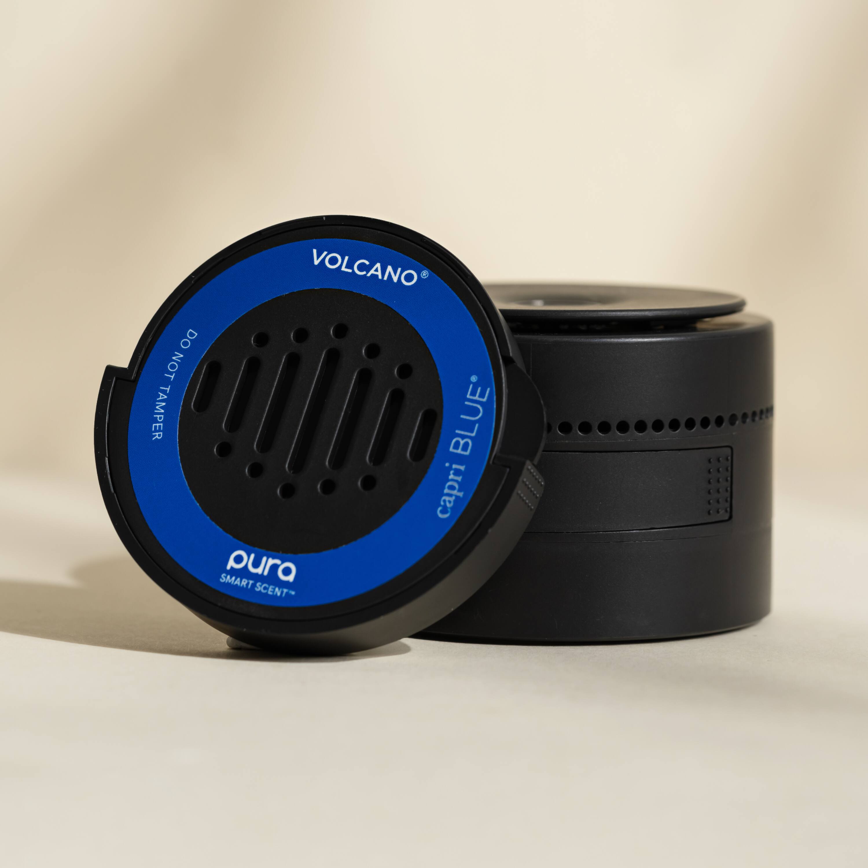 The text on the image is: "Volcano e Do Not Tamper Smart Pura Scent Blue* Capri 1.1 - 1.1."