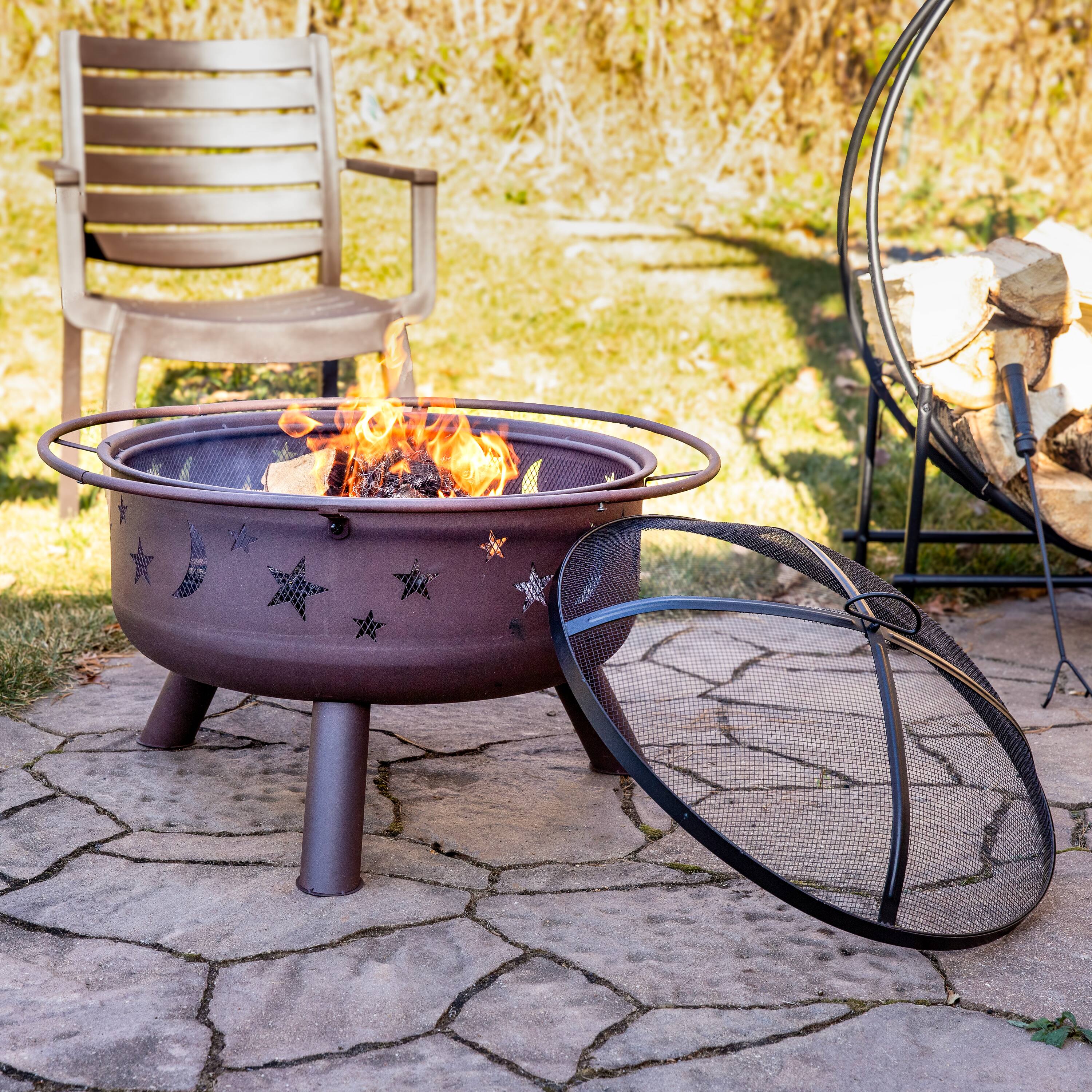 Alt View 1. Sunnydaze - 30 in Cosmic Steel Fire Pit with Spark Screen, Poker, and Grate - Bronze.
