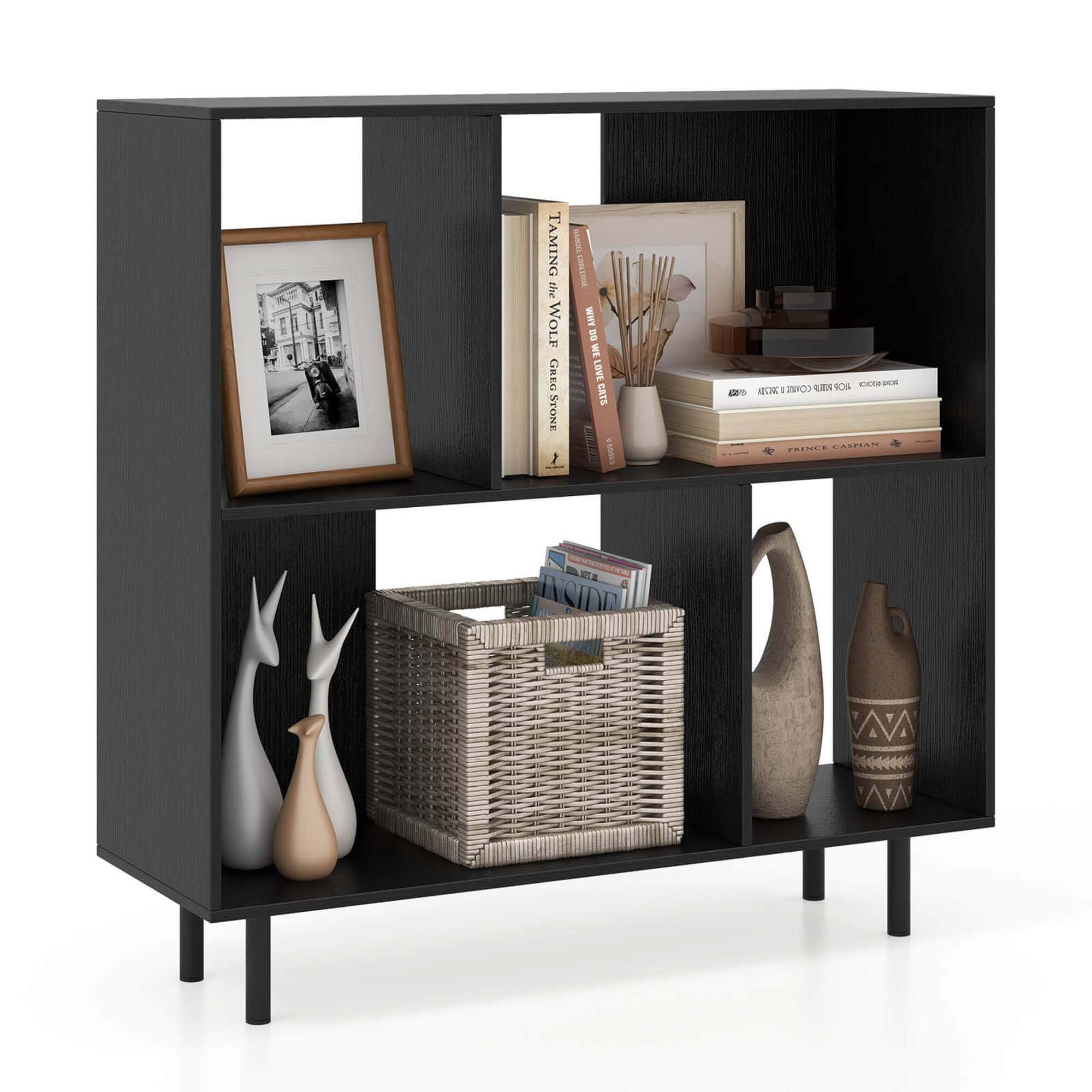 Taming the Wolf by Greg Stone is a book that is displayed on the shelf along with other books. The shelf is part of a black bookcase that also holds vases and a basket.