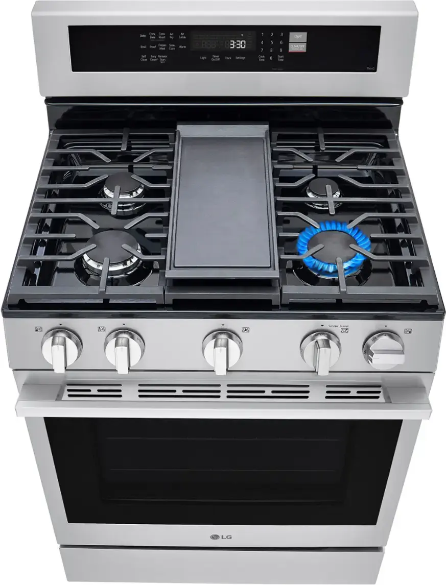 The image shows a stainless steel stove with a blue knob on the front. The stove has four burners, and the oven is located below the stovetop. The time displayed on the oven is 3:30.