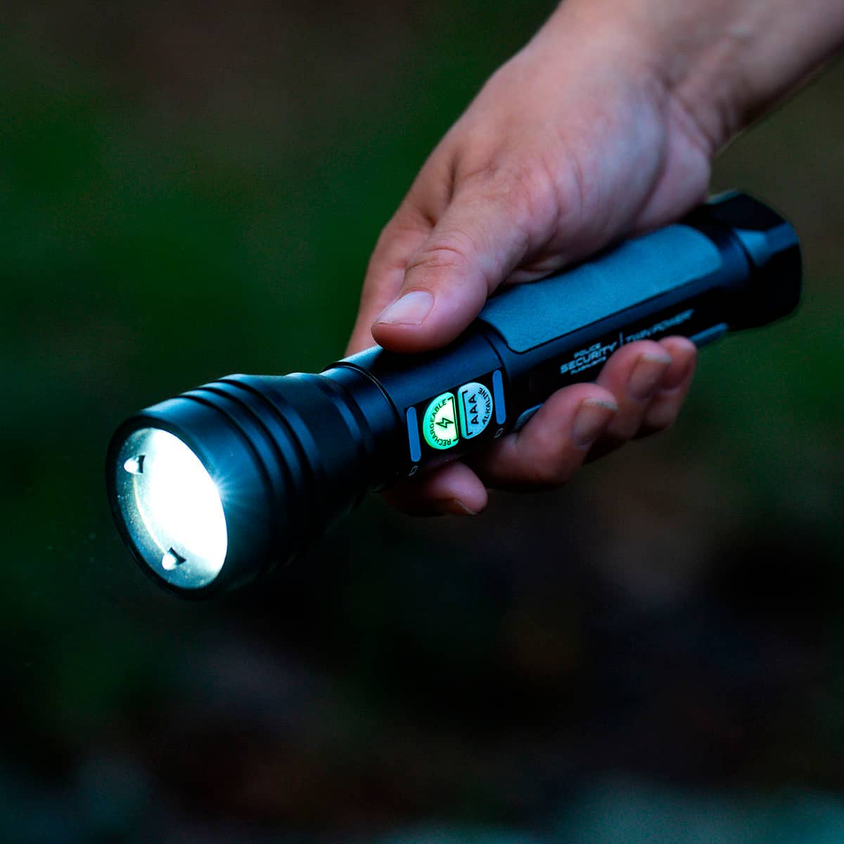The text on the image reads "GEABLE ISS AAA ALMALIN ma SECURITY POLEW". However, this text appears to be unrelated to the main focus of the image, which is a person holding a flashlight. The text might be a description or a caption for the image, but it does not provide any context or information about the flashlight itself.