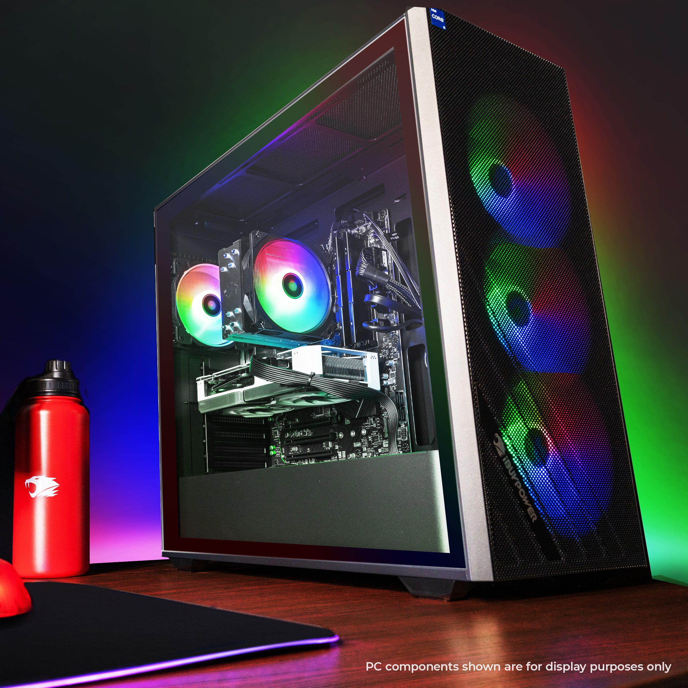 The image features a computer tower with a colorful light show, including a rainbow light. The PC components are displayed for show purposes only, and not for actual use.