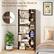 The product can be fixed to the wall for security. It comes with two anti-tipping devices to ensure stability. The shelf is made of wood and can hold various items such as books, vases, and bottles. It is a versatile piece of furniture that can be used in different rooms, like a bedroom or a living room.