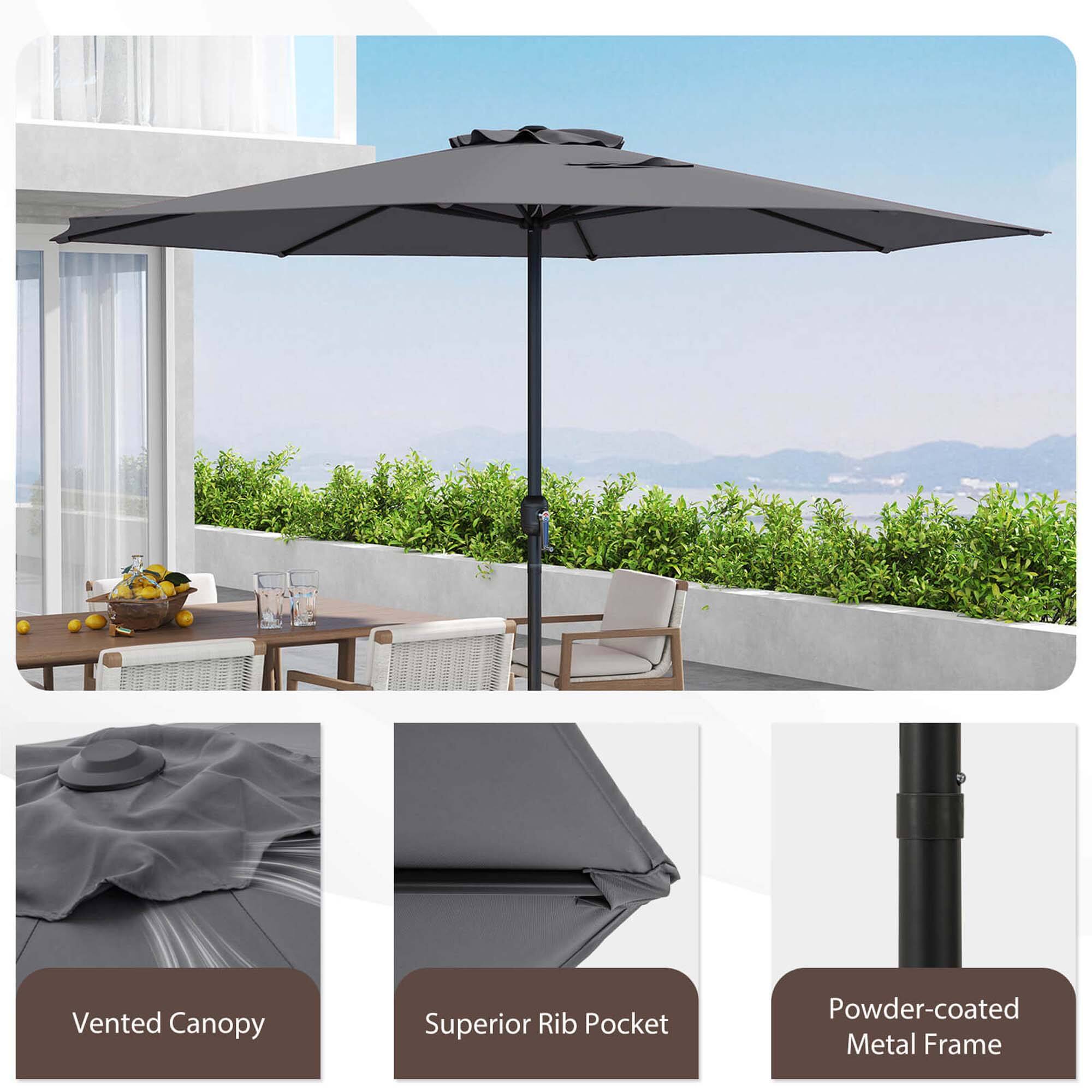 The image shows a large black umbrella with a vented canopy, superior rib pocket, and powder-coated metal frame. The umbrella is open and positioned on a table, surrounded by chairs. The table and chairs are located on a patio, providing a comfortable outdoor seating area. The umbrella is designed to protect people from the sun and rain, making it an ideal choice for outdoor gatherings or relaxation.