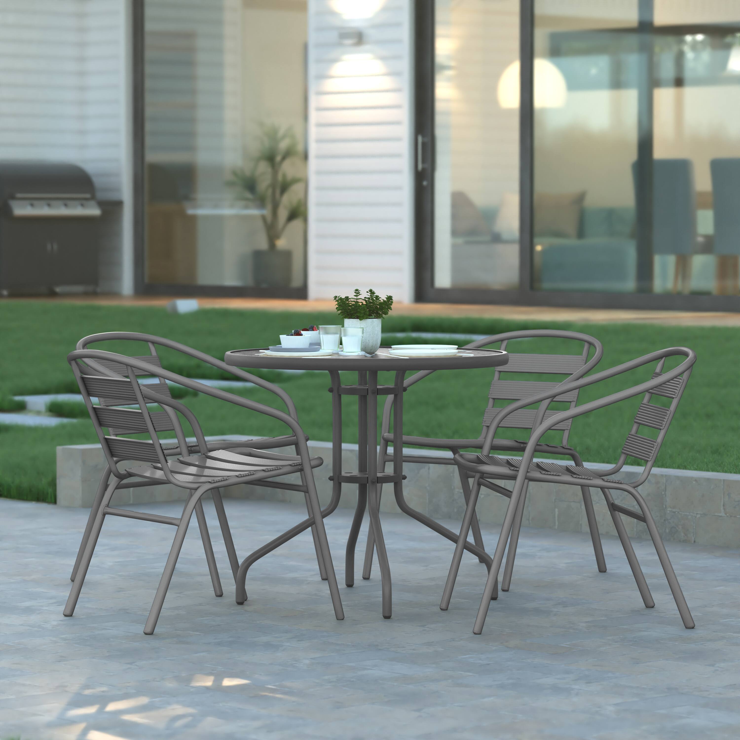 Alt View 1. Emma + Oliver - Rhea 31.5'' Round Glass Top Metal Table with 4 Aluminum Slat Stack Chairs - Silver.
