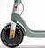 The image shows a close-up of a wheel on a scooter or motorized bike. The wheel is large and has a unique design, making it stand out. The scooter or motorized bike is green in color, and the wheel is prominently featured in the image. The focus of the image is on the wheel, showcasing its distinctive appearance and size.