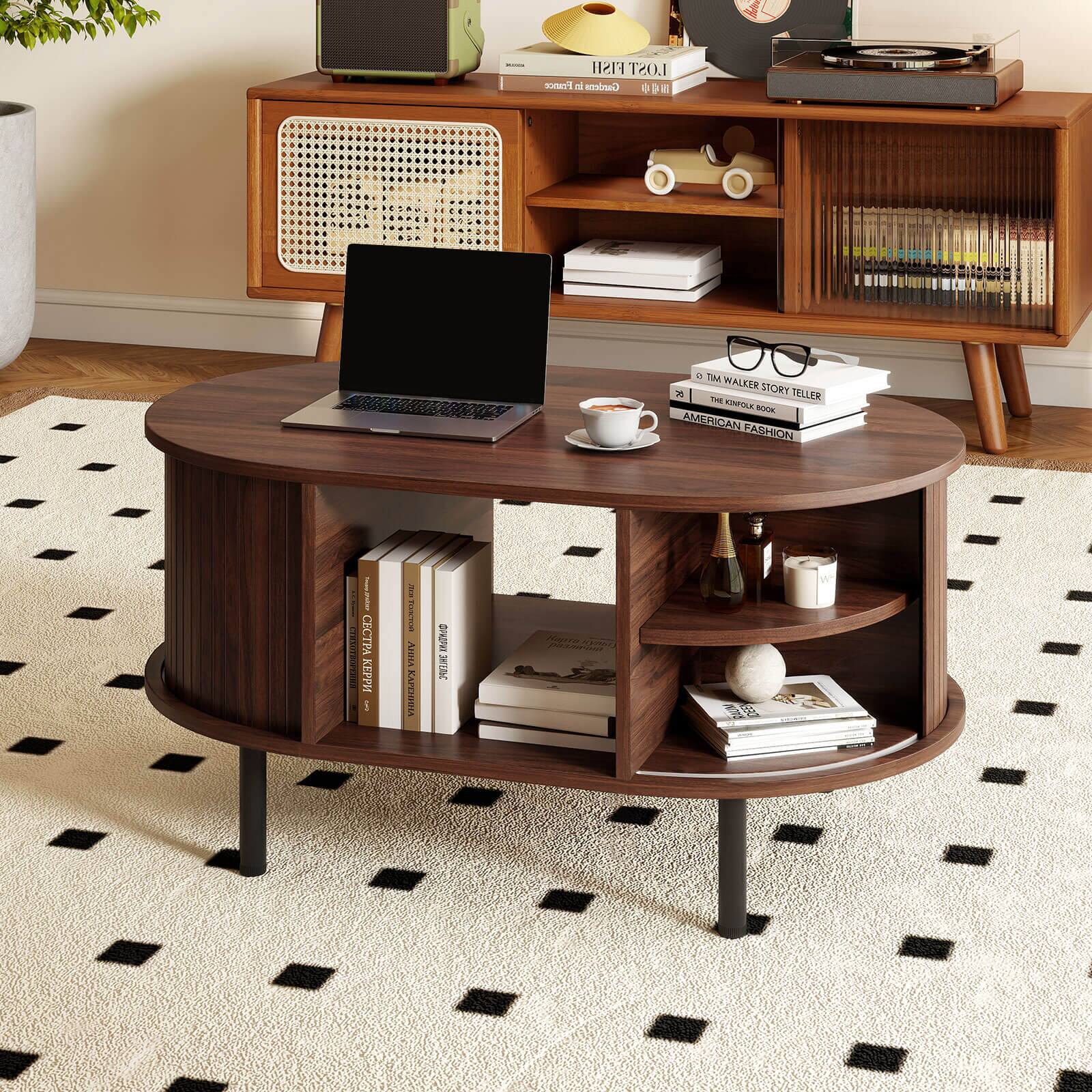 The image features a wooden coffee table with a laptop computer on top of it. The table is surrounded by various books and a cup of coffee. The table is placed on a checkered carpet, and there is a record player nearby. The scene also includes a potted plant and a vase, adding to the cozy and inviting atmosphere.