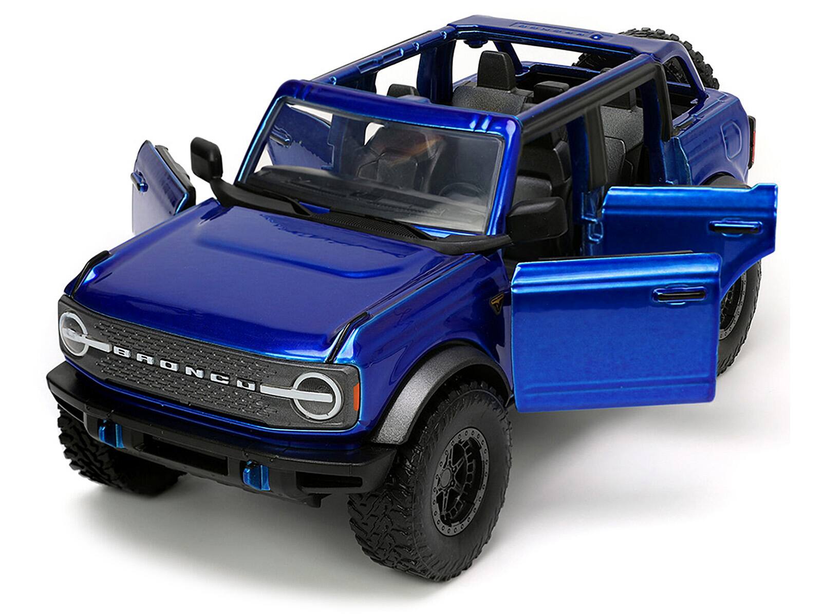 Angle. Jada - 2021 Ford Bronco Open-Top Candy Blue Metallic with Extra Wheels "Just Trucks" Series 1/24 Diecast Model Car by Jada - Candy Blue Metallic.