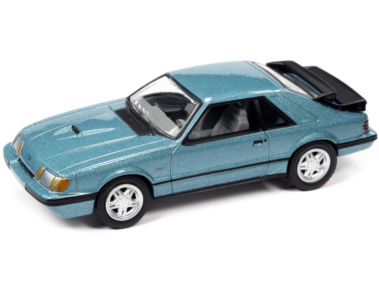 Alt View 1. Johnny Lightning - 1986 Ford Mustang SVO Light Regatta Blue Metallic w/Black Stripes Ltd Ed to 12768 pcs 1/64 Model Car by Johnny Lightning.