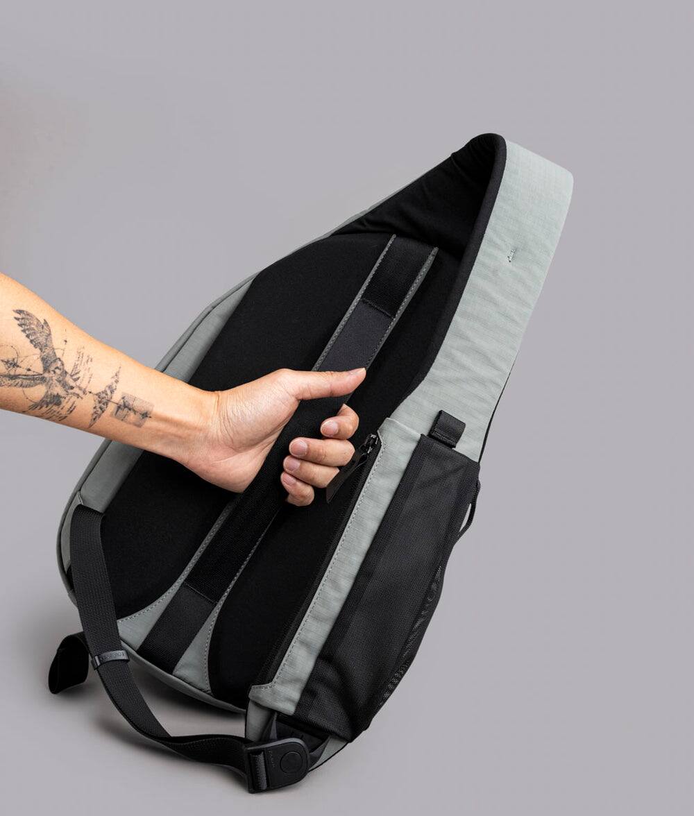 Back. ALPAKA - Crossbody Sling Bag 7.5L (Left Shoulder) for Men, Fits 11" Tablet, Phone Sleeve, Bottle Pocket, Luggage Pass-Through - Grey Axoflux 210D.