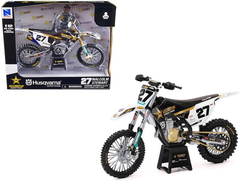 - WEdd MEIL Husqvama BOGaCE NewPay OTA cB 1:12 knqvama DI-CRST -- PLASTIC ROCKSTINR - 27  H OOOCE Husovama 14+ JR MALCOLM H Husqvarna 27 STEWART ROCKSTAR PACTORY RACMES WARNING: CHOKING HAZARD-Iea - SNERS ...R - fo cdes ander I gears BUNIOR - 27 CRET Od ROCKSTAR ENERGY DRINK 6  H  MOTOREX ROCKSTOR 27 GUTB A 27 FECEL RK