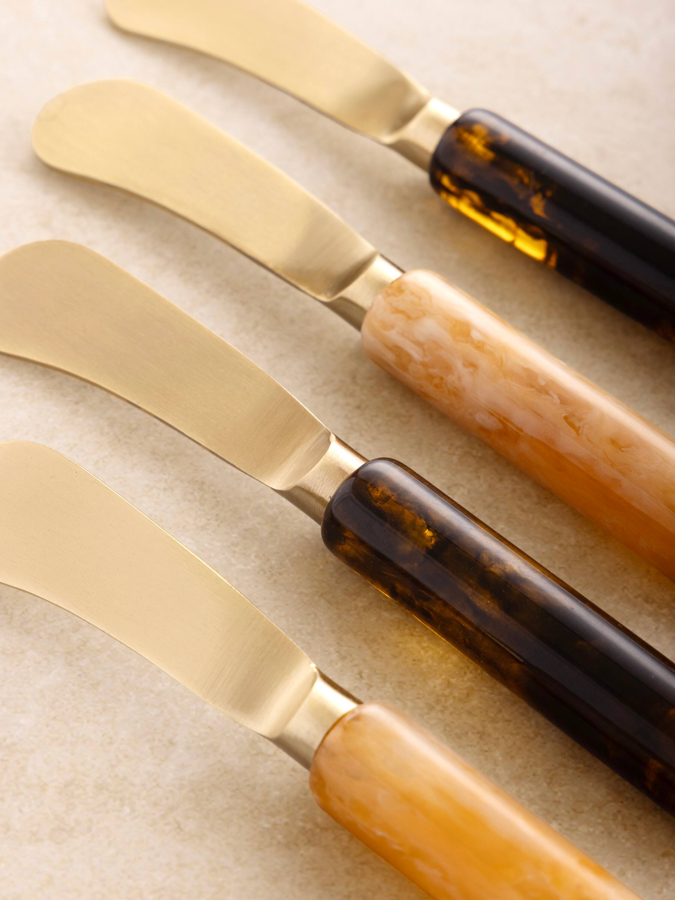 Left. GAURI KOHLI - Sydney Butter Knives - Shades of brown, matte gold.