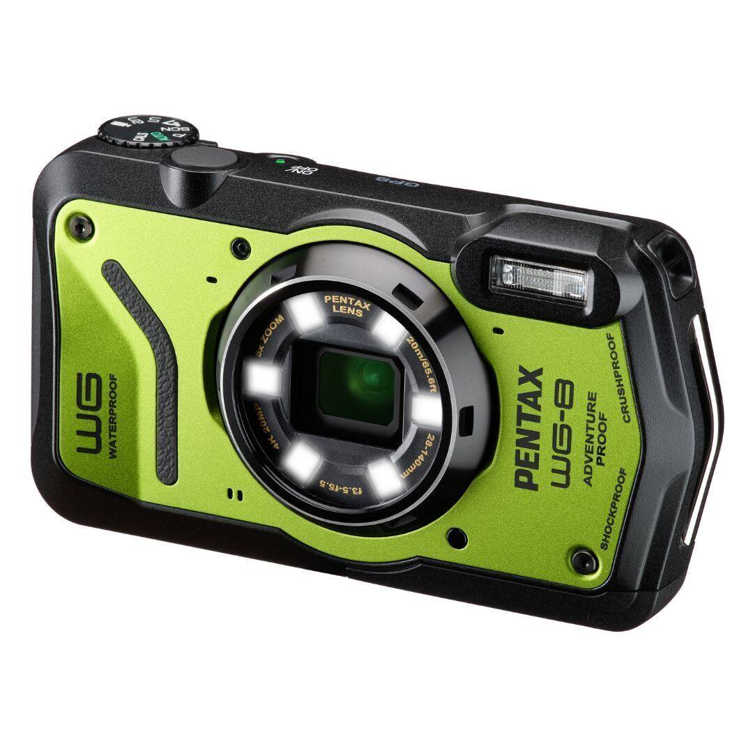 The image features a green camera with a Pentax lens, which is waterproof, shockproof, and crushproof. The camera is designed for outdoor adventures and has a zoom feature, allowing for a 20m/65.6ft focal length. The camera is equipped with a 28-140mm lens, which provides a versatile range of focal lengths for capturing various subjects and scenes.