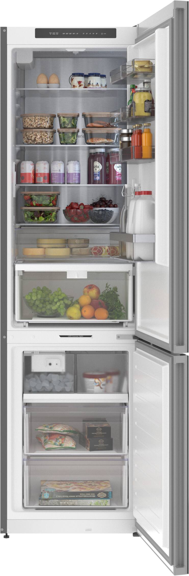 A refrigerator is full of food, including a variety of fruits and vegetables. The image shows the inside of the refrigerator with its door open, revealing the contents. The refrigerator is stocked with items such as oranges, apples, and broccoli, among others. The arrangement of the food items suggests that the refrigerator is well-organized and ready for use.