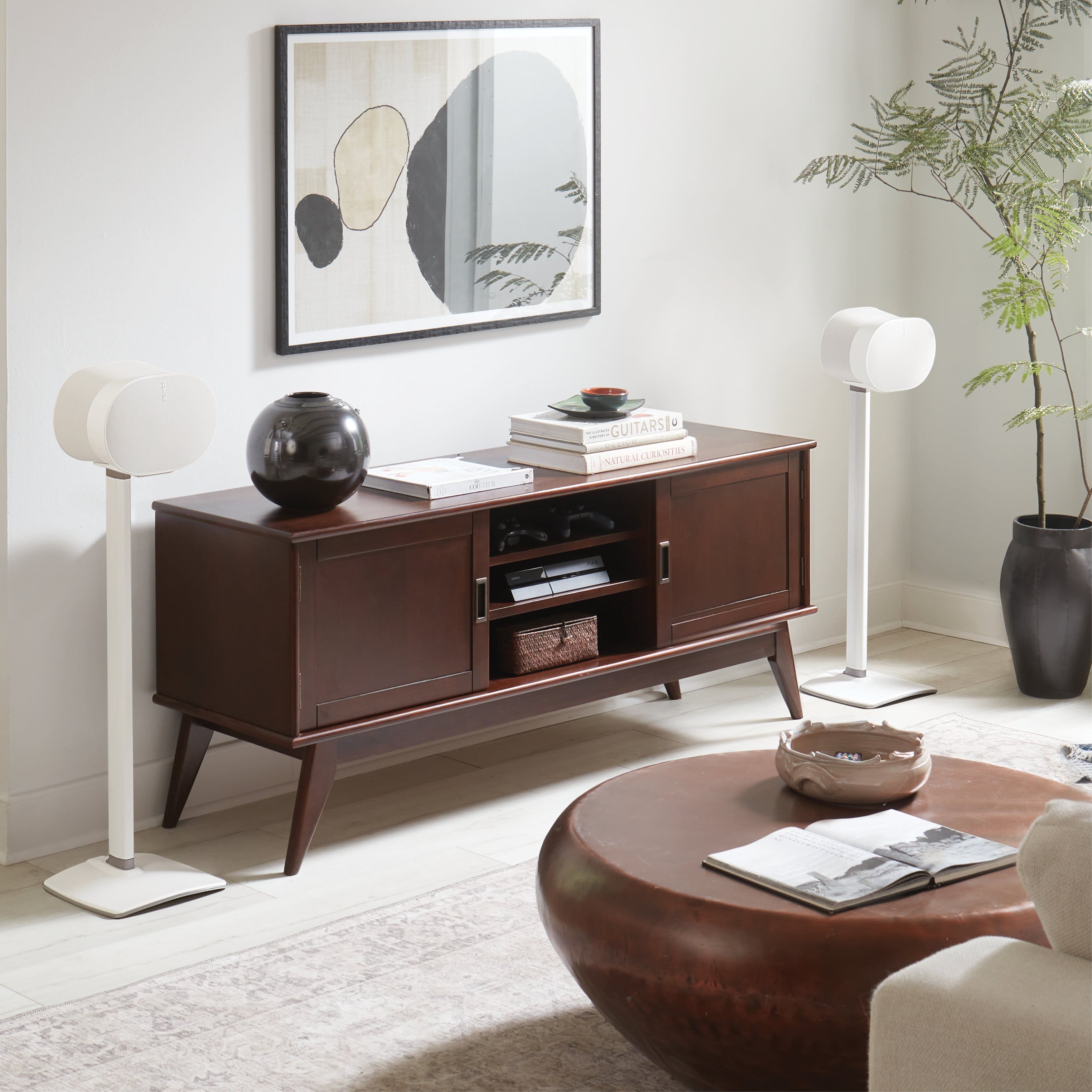 I'm sorry, but I cannot group or correct the text as it doesn't seem to be related to the image. The image shows a living room with a brown wooden cabinet, a round table, a couch, and a potted plant. There is also a bowl on the table and a book on the couch.