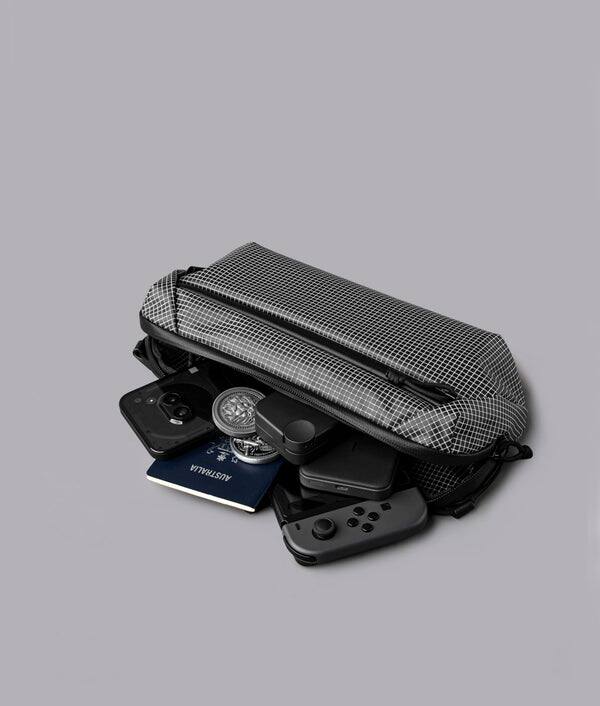 Alt View 4. ALPAKA - Lightweight Crossbody Sling Bag for Travel, Phone, Wallet & Passport, Momentum Sling, Weather-Resistant - Axodyne hybrid Grey.