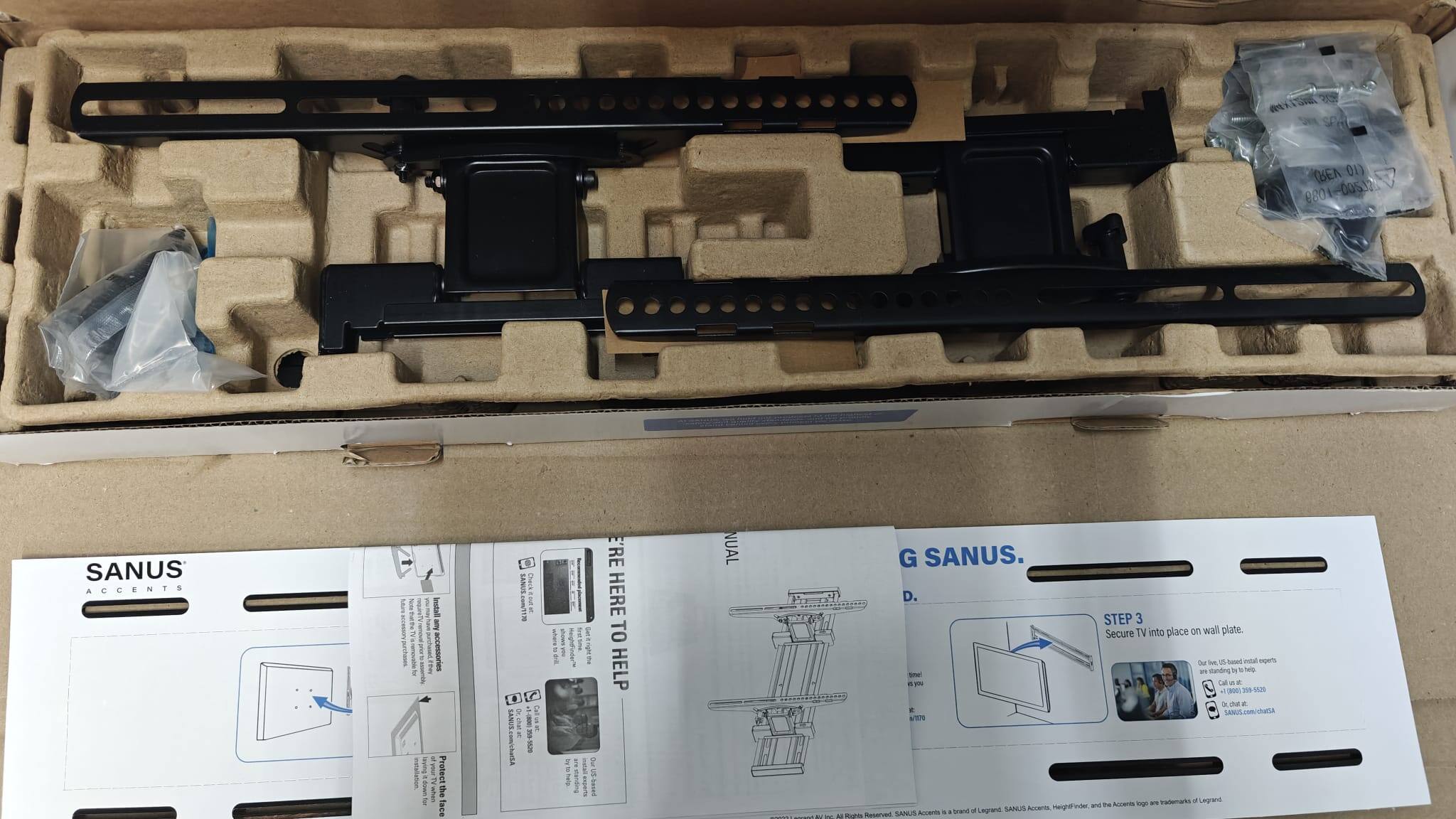 01) 1089 00512 SANUS ACCENTS  
E I Am - accessories C I Protect TV  
whas face SANE.comTTM 1 C SOAYS PSS Callusat 1 T an I 1 I E I 5 standing 'RE HERE TO HELP NUAL G SANUS. D.  
STEP 3 Secure TV into place on wall plate.  
Ou 3 &S Satel eta eoms -. standing De W p - n5 e - . - -ON 300-1555 a me . * SANUS.com/chuta - Avts egr ws Irademarks d Legrand ieightfinder and t trand a Laegrand SANUS Accerts SANUS Accents - I - - 1 & Sua Reserved