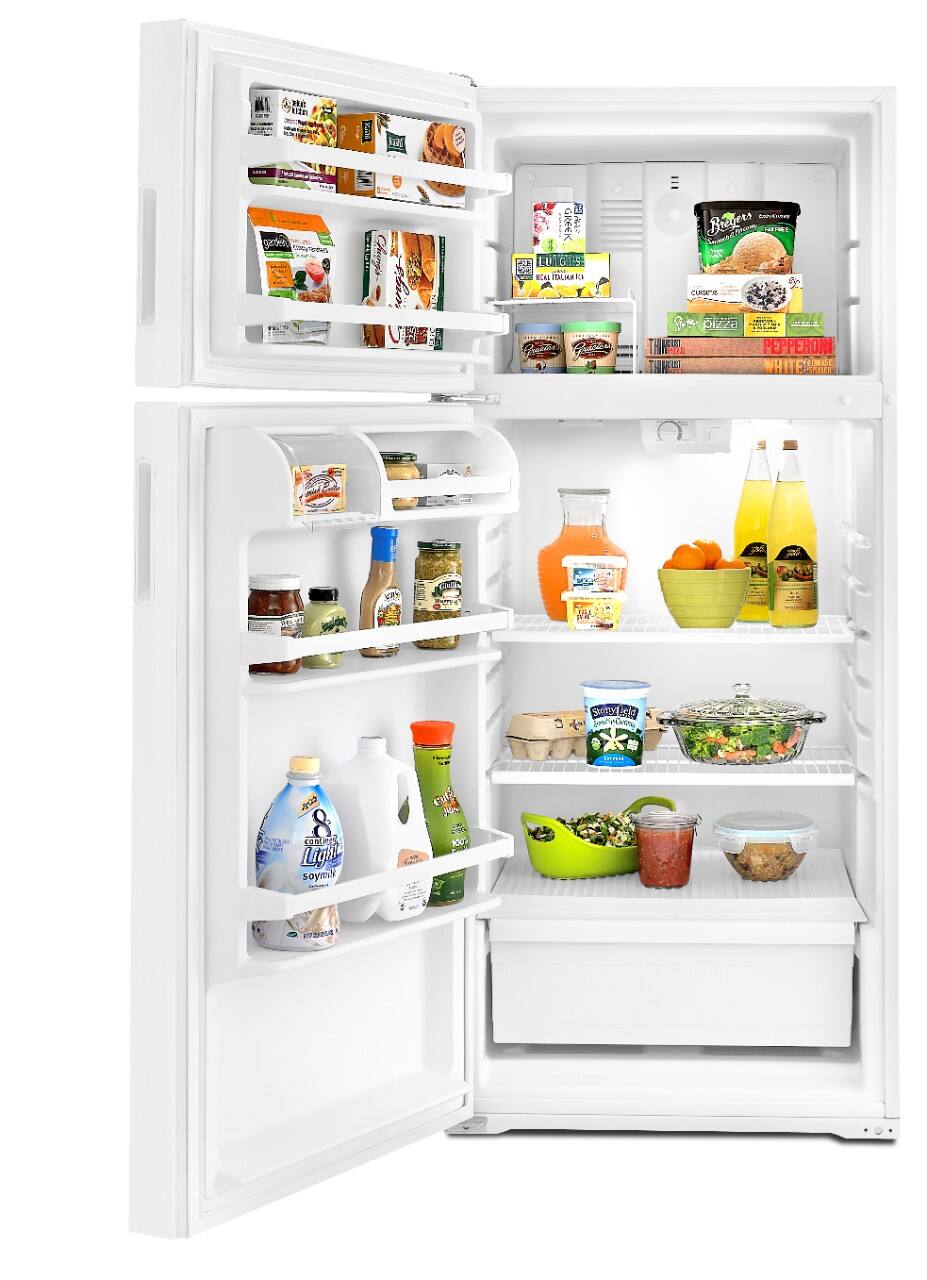 In a kitchen, I found a refrigerator filled with various items. The shelves are stocked with a variety of food and beverages. On the top shelf, there are boxes of cereal and other packaged goods. The middle shelf has jars of condiments, including mustard and mayonnaise. The bottom shelf contains a gallon of milk, a carton of eggs, and a container of yogurt. There are also bottles of orange juice and a carton of eggs. The door shelves hold more condiments and a bottle of soy milk.
