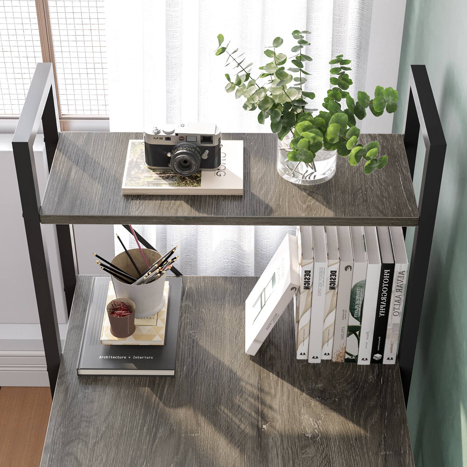 The image features a wooden table with a variety of items on it. There is a bookshelf with several books, a vase with greenery, a camera, and a cup. The table is located near a window, allowing natural light to illuminate the scene. The arrangement of the items on the table creates a cozy and inviting atmosphere, making it an ideal space for reading, photography, or simply enjoying the view outside.