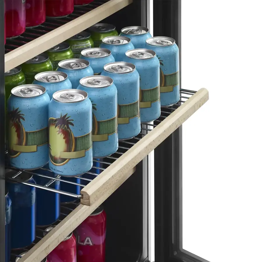 The image shows a refrigerator with a shelf full of various canned drinks. There are a total of 14 cans, including a mix of different colors and flavors. The cans are arranged in a way that they are easily accessible and visible to the user. The refrigerator is designed to store and display these drinks in an organized manner, making it convenient for the user to find and enjoy their preferred beverage.