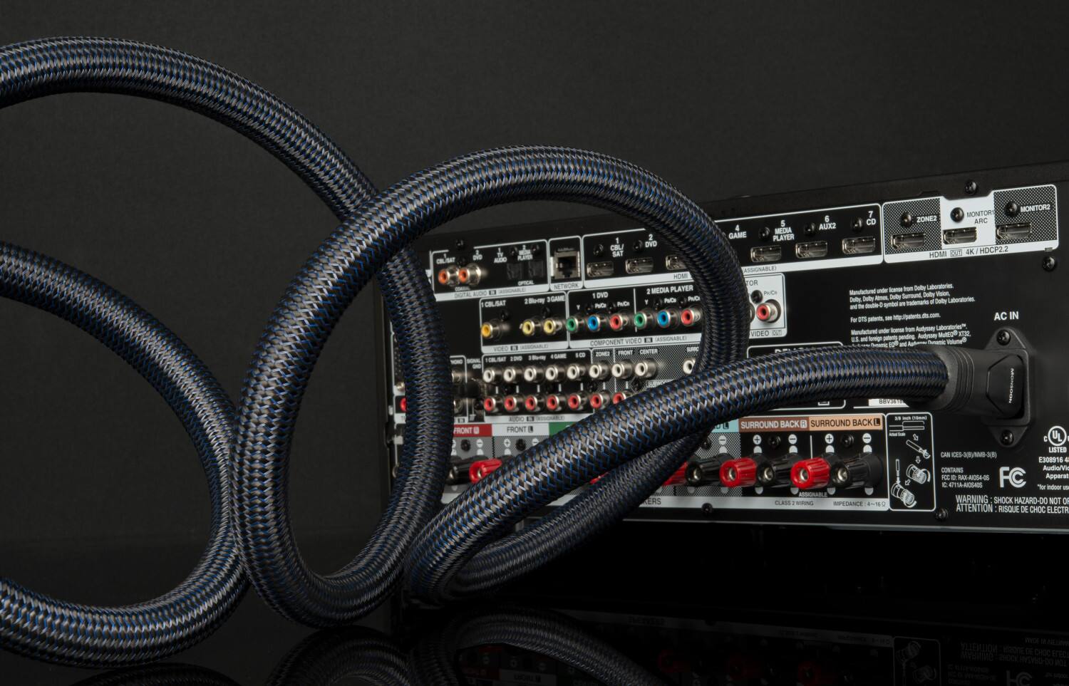 The text on the image is a description of a product, which includes various features and specifications. The product is a cable box with a blue cord, and it is designed for use with a DVD player, TV, and monitor. The box also has a component video output, which allows for high-definition video and audio. The product is compatible with 4K/HDCP2.2, and it has a surround sound system. The box is also equipped with a Dolby Laboratories manufactured under license Dolby Surround sound system, which enhances the audio experience. The product is UL listed and contains a warning about the risk of shock hazard, advising users to pay attention to the instructions.