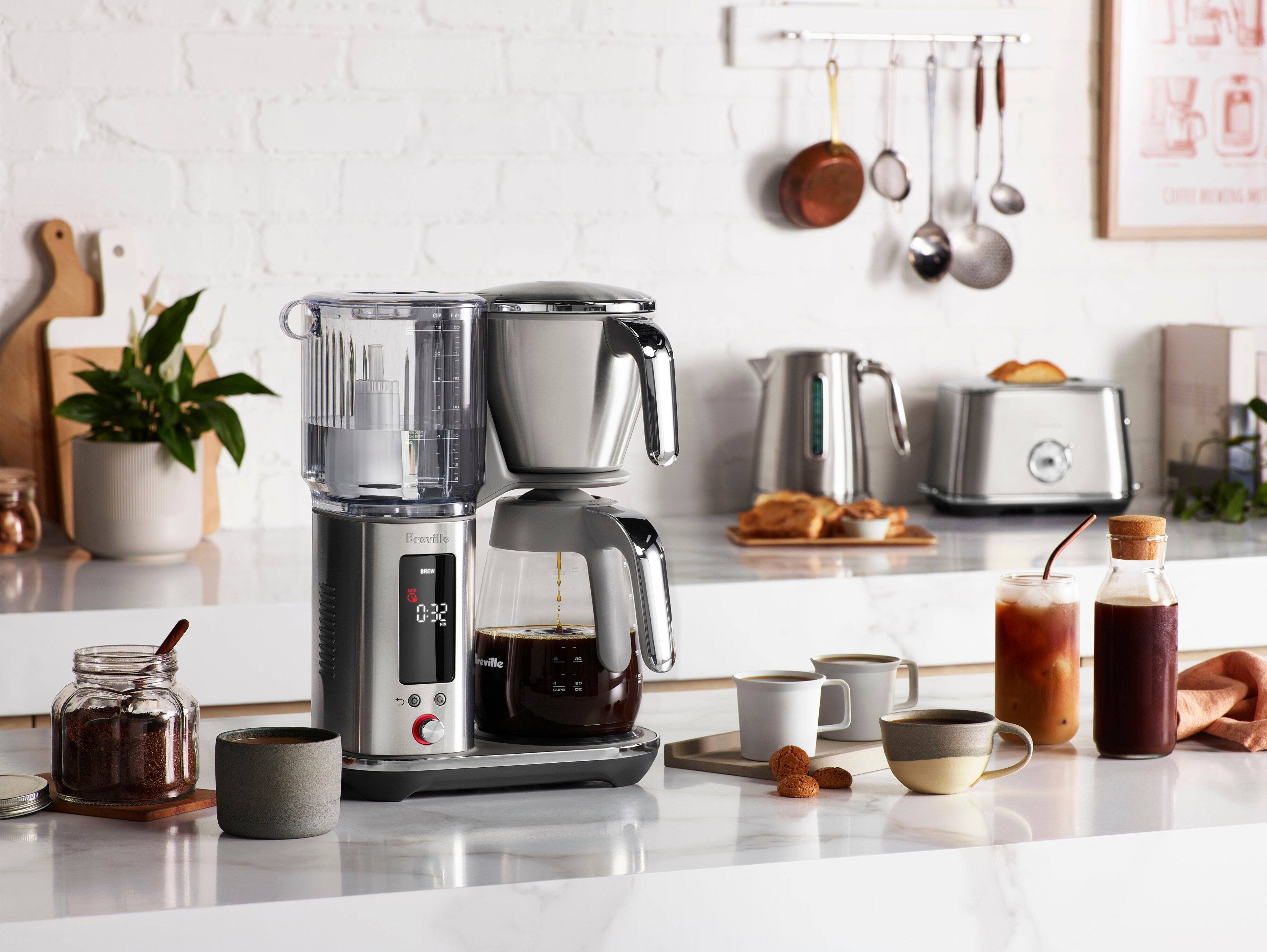 The text on the image reads "J L0 Freville - S 032 rville." However, it is not clear what this text refers to or its relevance to the image. The image features a kitchen counter with various kitchen appliances, such as a coffee maker, blender, toaster, and other items.