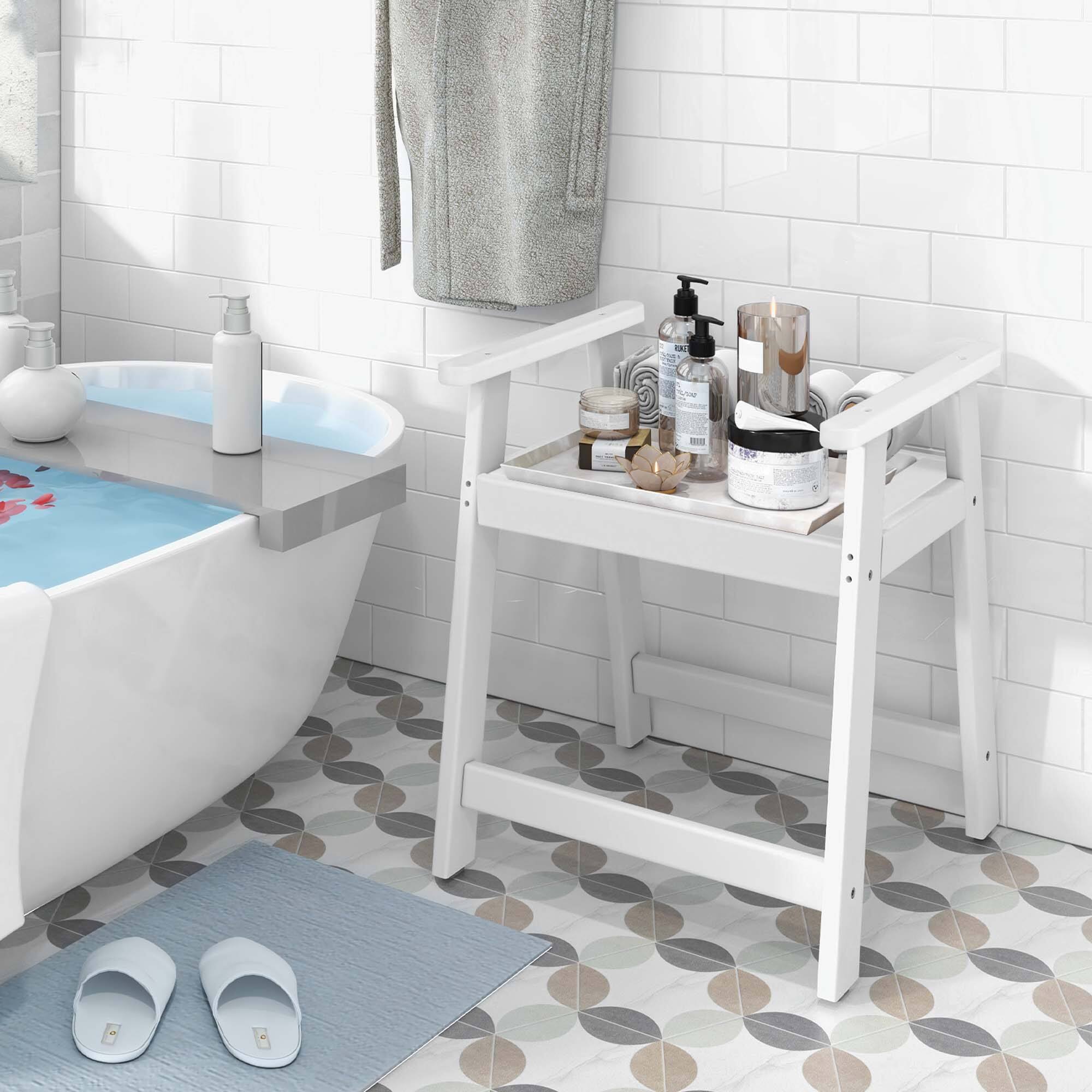 The image features a bathroom with a white bathtub, a towel rack, and a small table. There is a blue bath tub filled with water, and a white towel is hanging on the rack. The table has various items on it, including a bottle, a cup, and a vase. The overall scene is clean and well-organized, with the toiletries neatly arranged on the table.