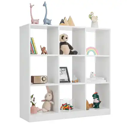 The image features a white bookshelf filled with various items, including books, toys, and decorative objects. There are several books of different sizes placed on the shelves, as well as a few teddy bears and other toys. Additionally, there are a few vases and a potted plant on the shelves, adding to the decorative elements of the bookshelf. The arrangement of these items creates a visually appealing and functional space for storing and displaying personal belongings.