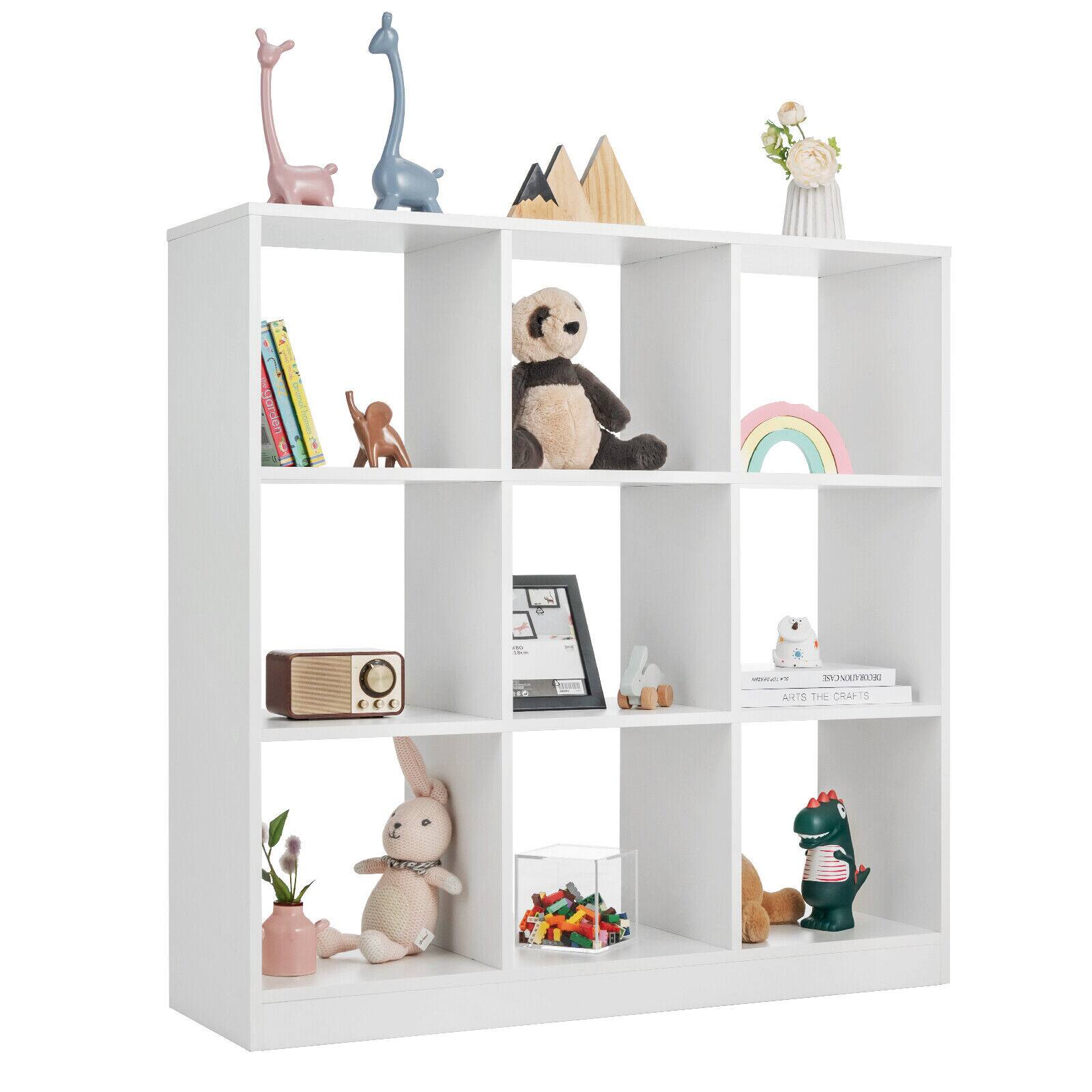 The image features a white bookshelf filled with various items, including books, toys, and decorative objects. There are several books of different sizes placed on the shelves, as well as a few teddy bears and other toys. Additionally, there are a few vases and a potted plant on the shelves, adding to the decorative elements of the bookshelf. The arrangement of these items creates a visually appealing and functional space for storing and displaying personal belongings.