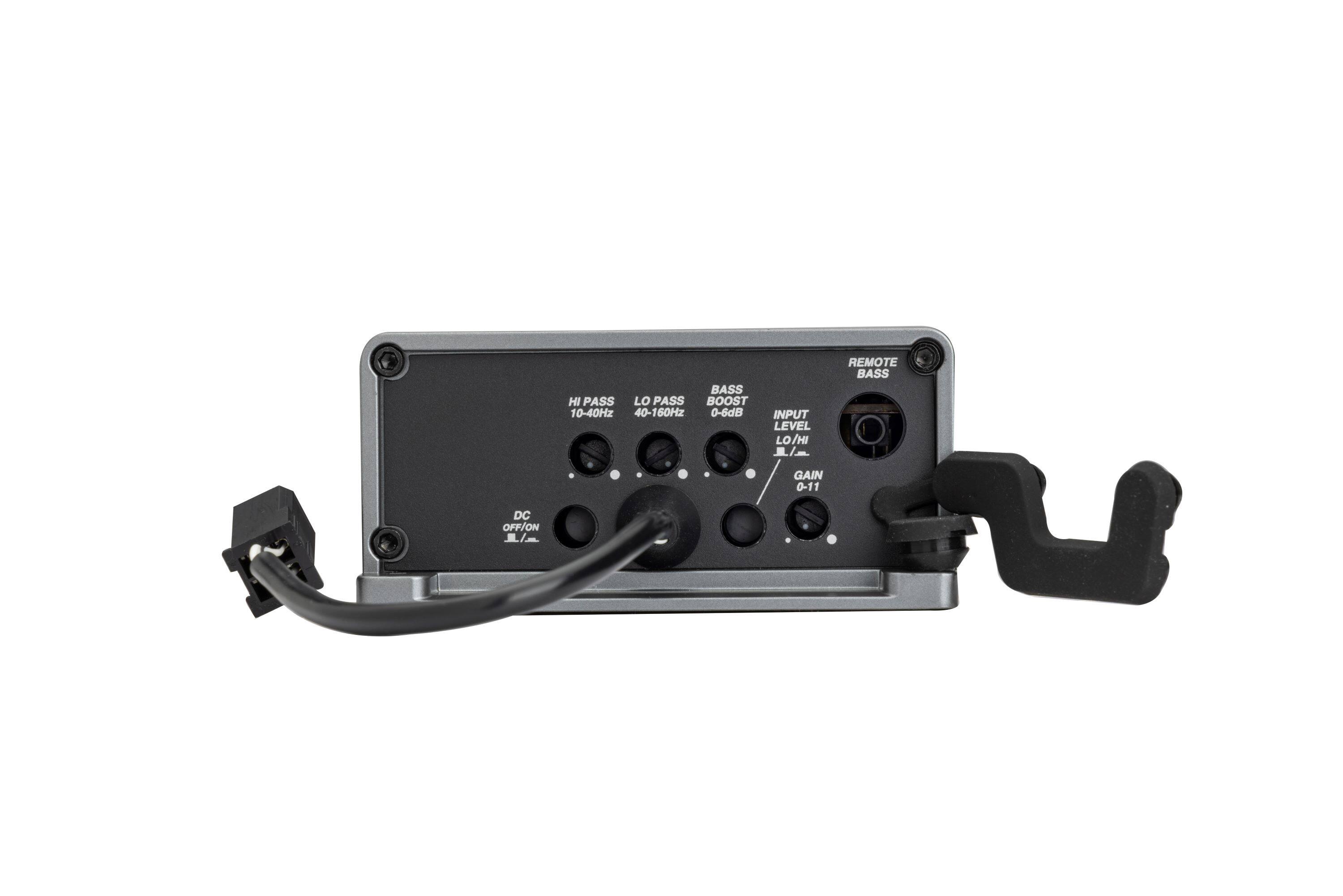 The image features a black electronic device with a remote control attached to it. The device has a bass booster and a pass filter, allowing users to adjust the input level and frequency range. The remote control has a range of settings, including a bass gain control, a pass filter, and a DC on/off function. The device is designed to enhance the audio experience by providing users with customizable options for their listening preferences.