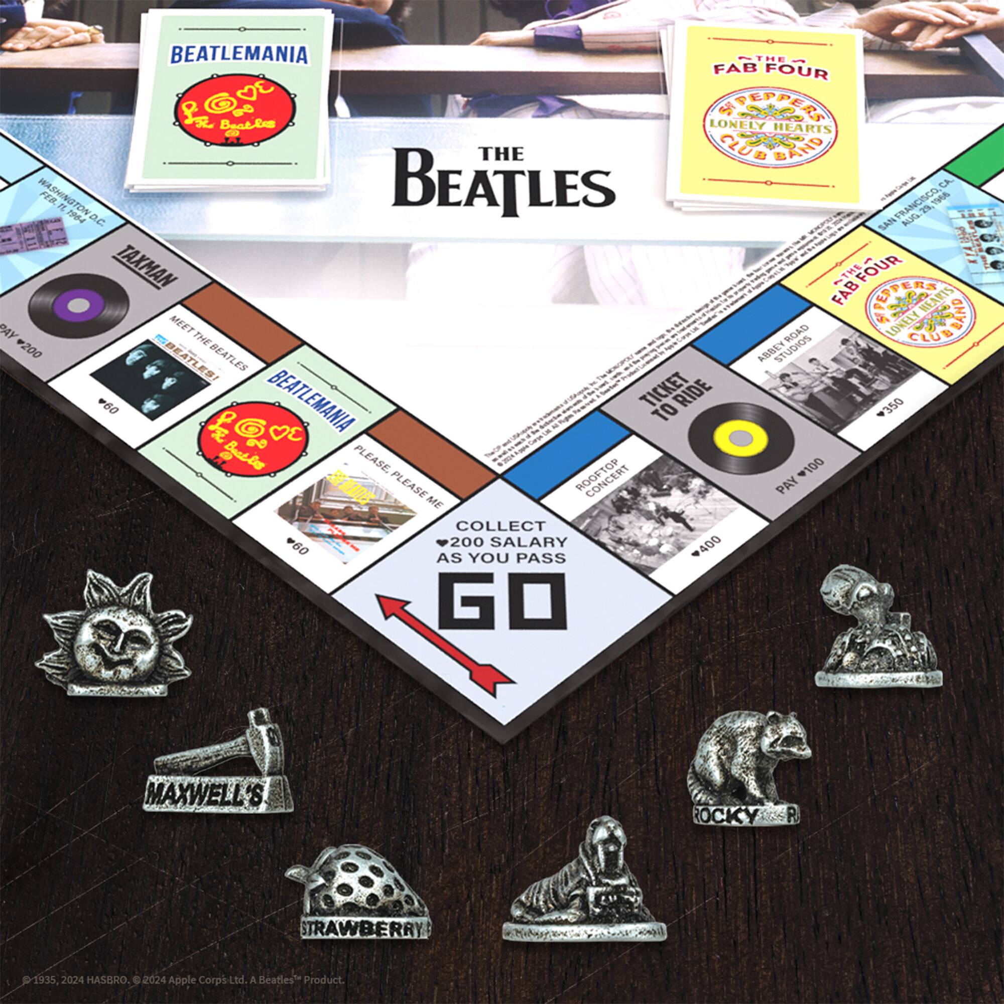 The text on the image is about a Beatles-themed board game called Beatlemania. The game is designed to be played in Washington D.C., San Francisco, and Los Angeles. The game involves collecting Beatles-related items, such as records, and paying taxes as you advance around the board. The game also includes a ticket to ride and a collector's item. The game is set up on a table with a board and various Beatles-related items, such as books and records, scattered around it.