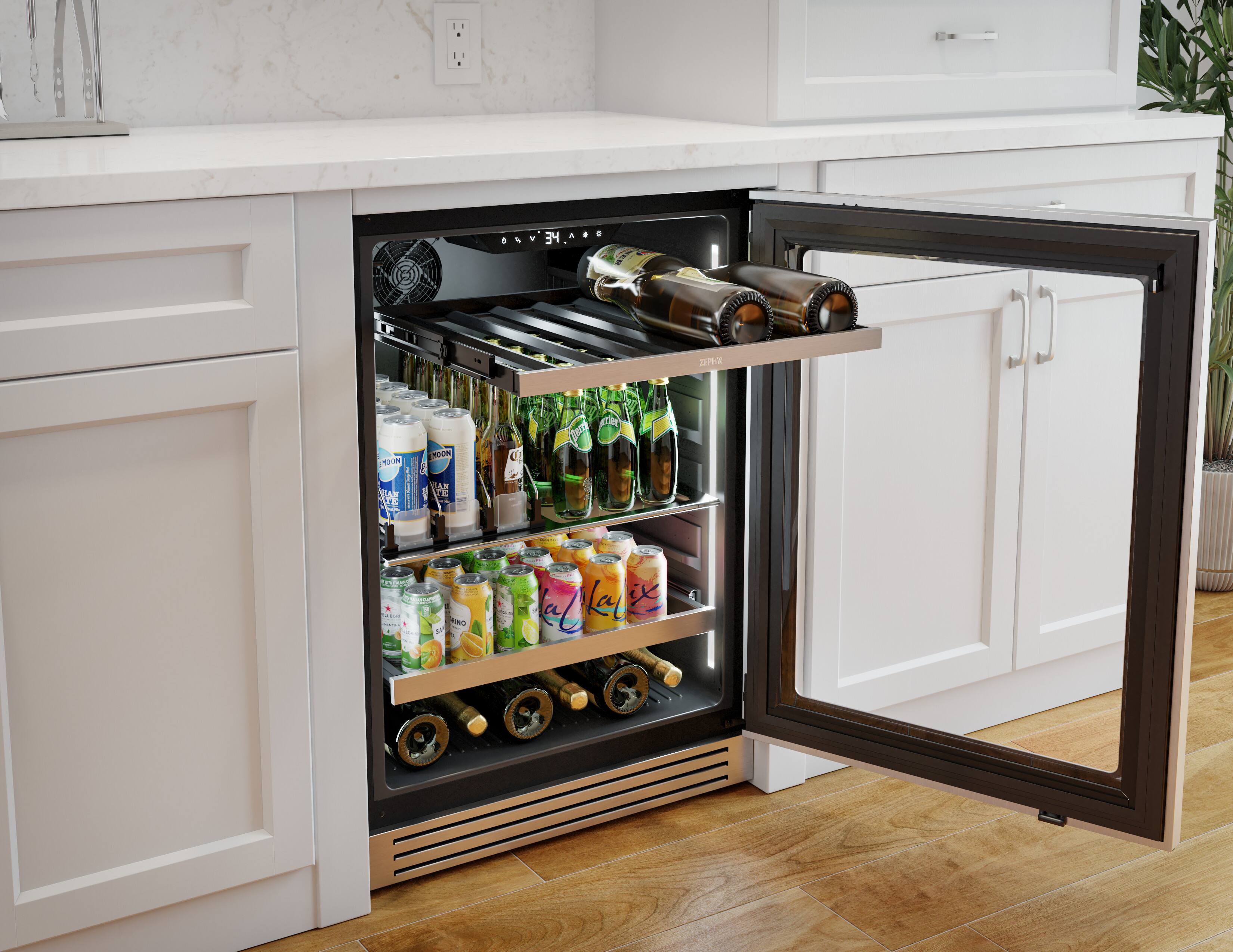 The image shows a kitchen with a refrigerator that has a drawer filled with various drinks. There are several bottles of water and soda, as well as a few bottles of wine. The refrigerator is located under a counter, and the drawer is open, revealing the assortment of drinks. The kitchen also features a sink and a potted plant, adding to the overall ambiance of the space.