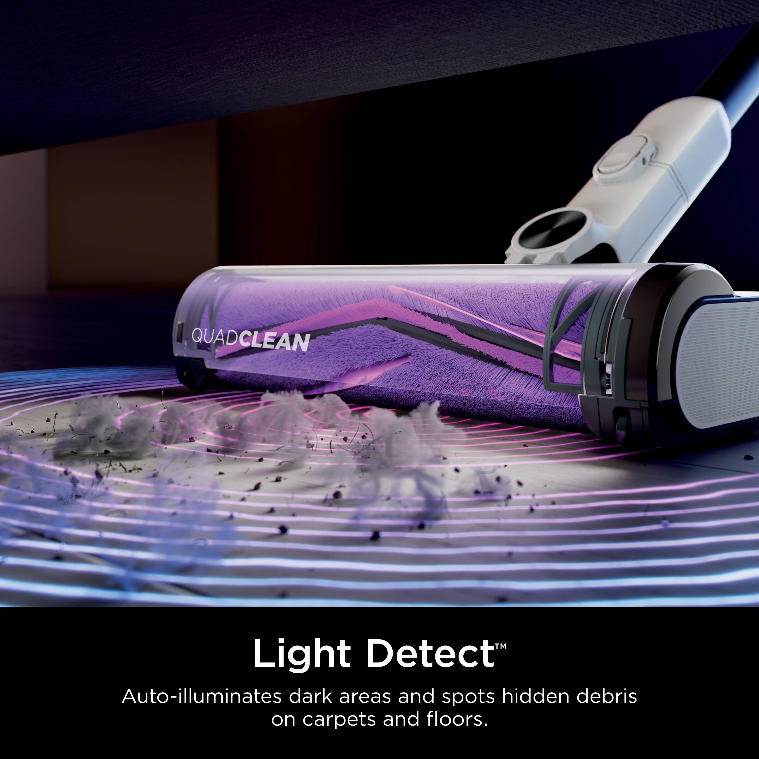 The text on the image reads: "QUADCLEAN Light Detect Auto-illuminates dark areas and spots hidden debris on carpets and floors."