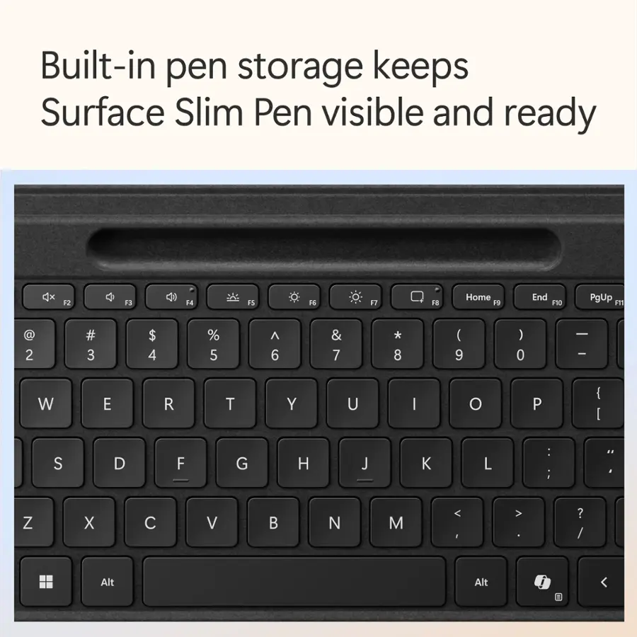 Built-in pen storage keeps Surface Slim Pen visible and ready. The keys on the keyboard include F2, F3, F4, F5, FG, 17, F8, Home, FS, End, F10, PgUp, F11, @, 2, #, 3, $ 4%, 5, ^, 6, &, 7, *, 8, (, 9), 0, -, I, W, E, R, T, Y, U, I, O, P, {, [, S, D, F, G, H, J, K, L, ;, .., Z, X, C, V, N, M, <, I>, ?, /, Alt, Alt.