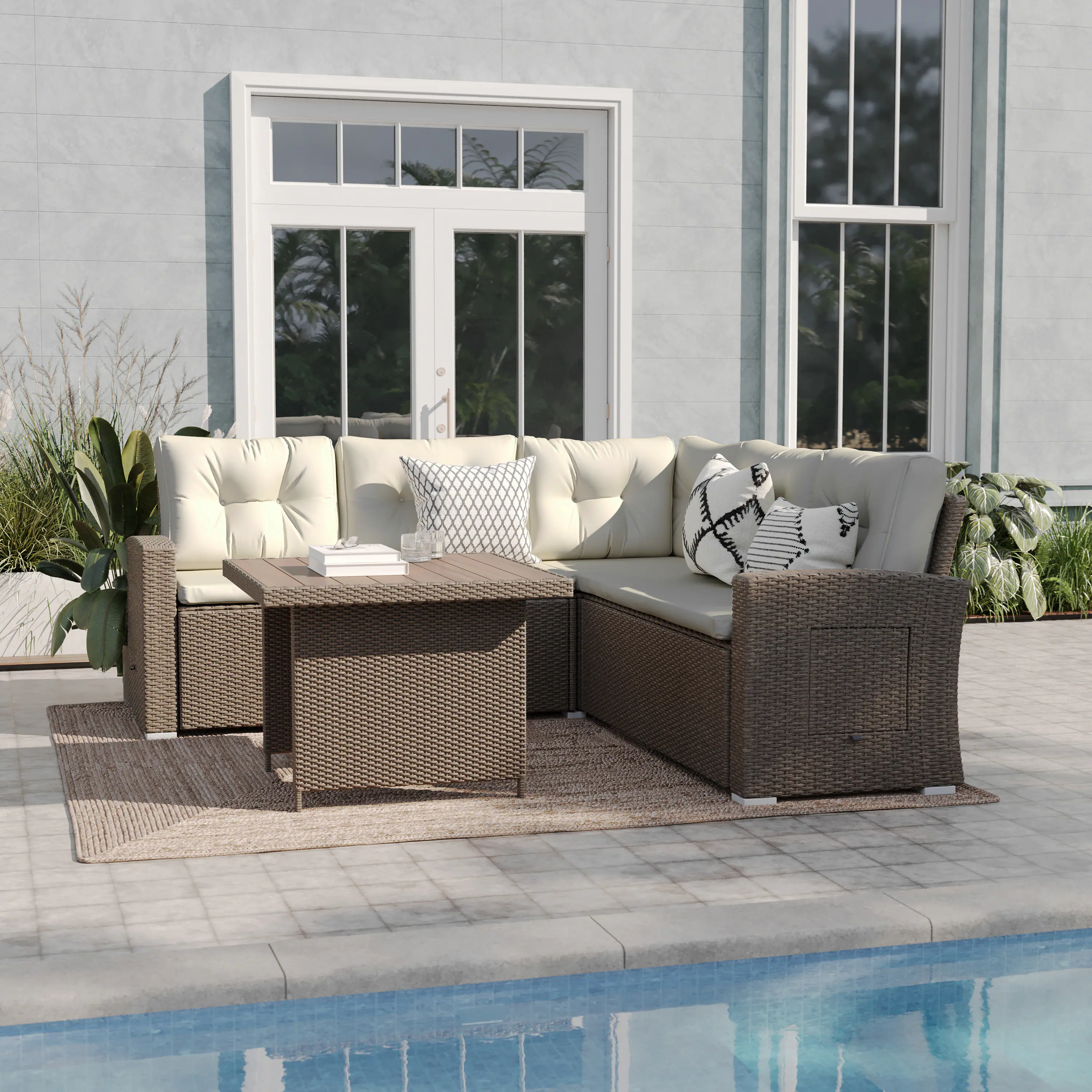 Outdoor wicker sofa and table set in a patio by a pool.